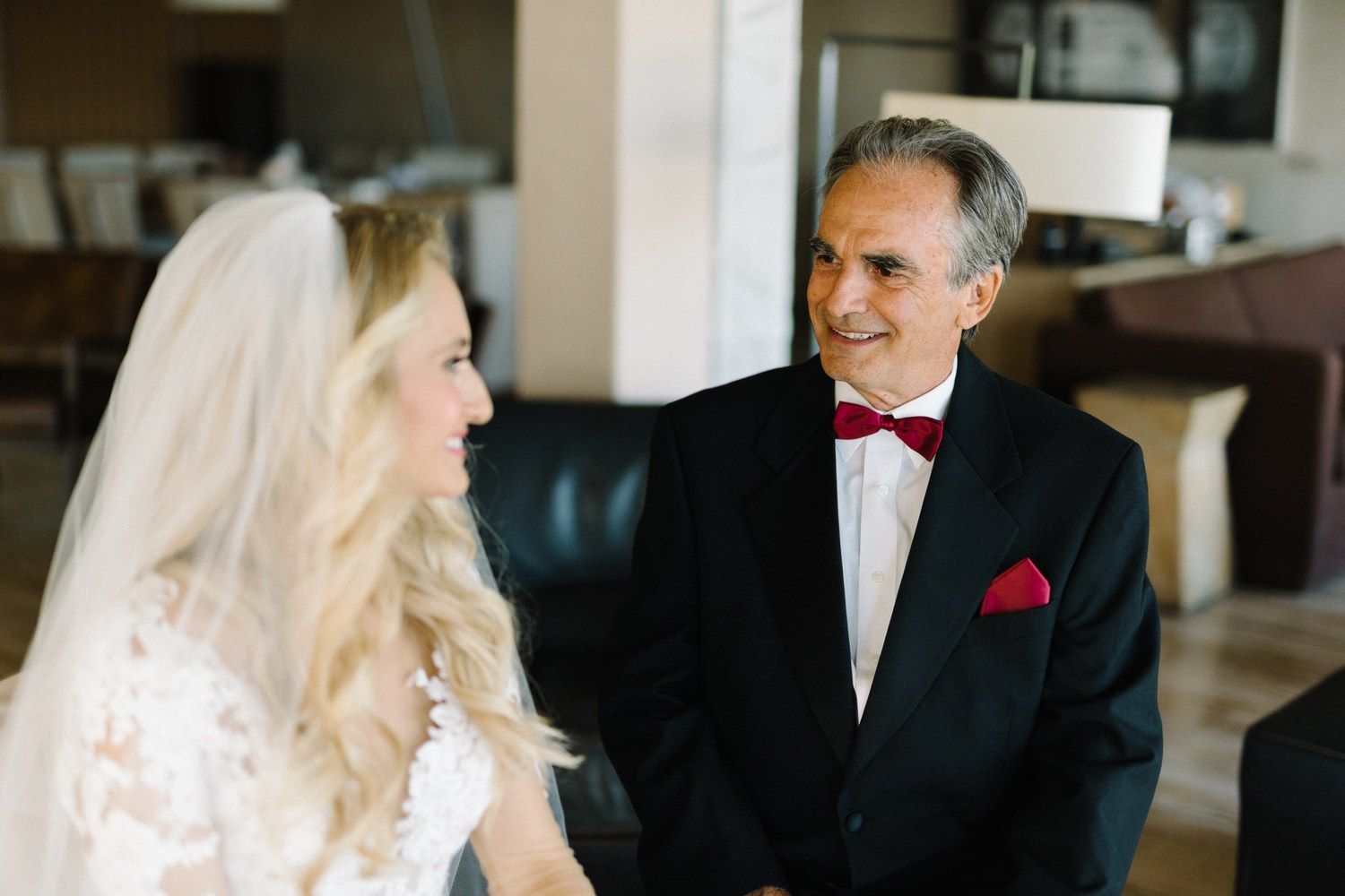 Candid wedding moment captured in indoor setting.