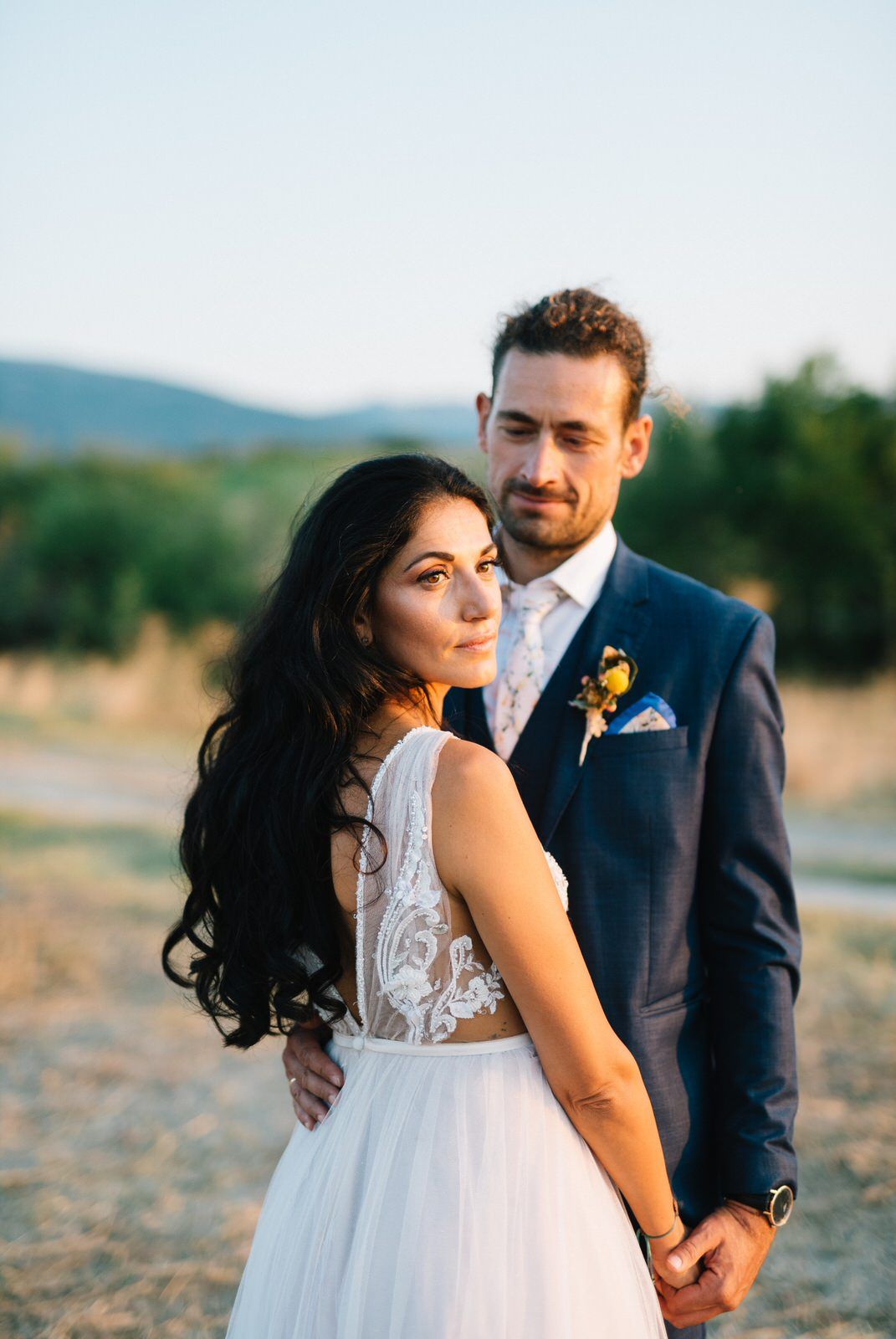 Elegant wedding portrait in countryside with afternoon light.