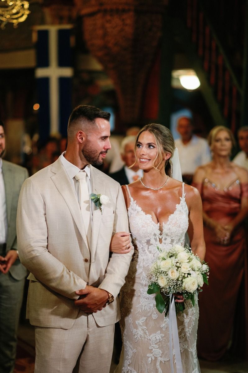 A romantic wedding ceremony moment in a church with elegant decor and lighting.