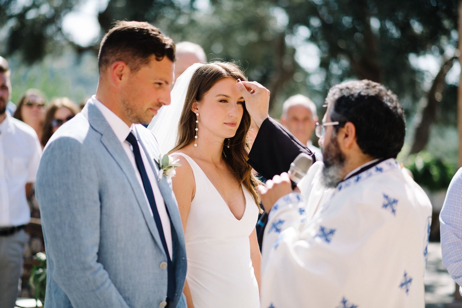 Sunny outdoor wedding ceremony at an elegant Mediterranean venue.