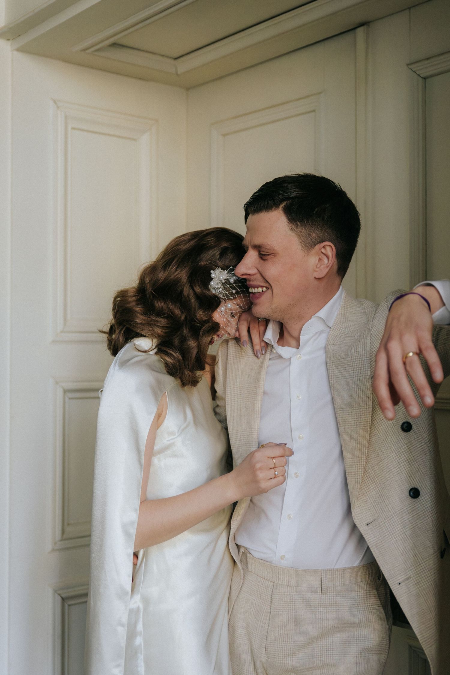 Elegant couple portrait in front of a historic manor house during a destination elopement