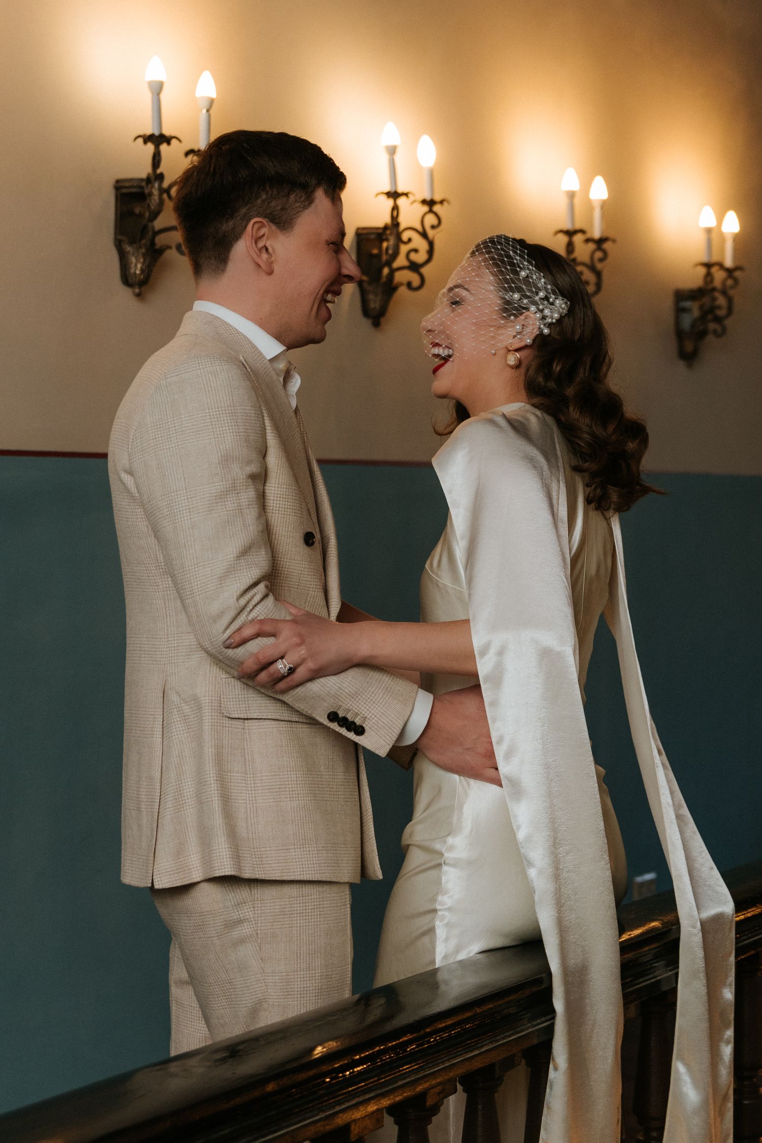 Elegant couple portrait in front of a historic manor house during a destination elopement