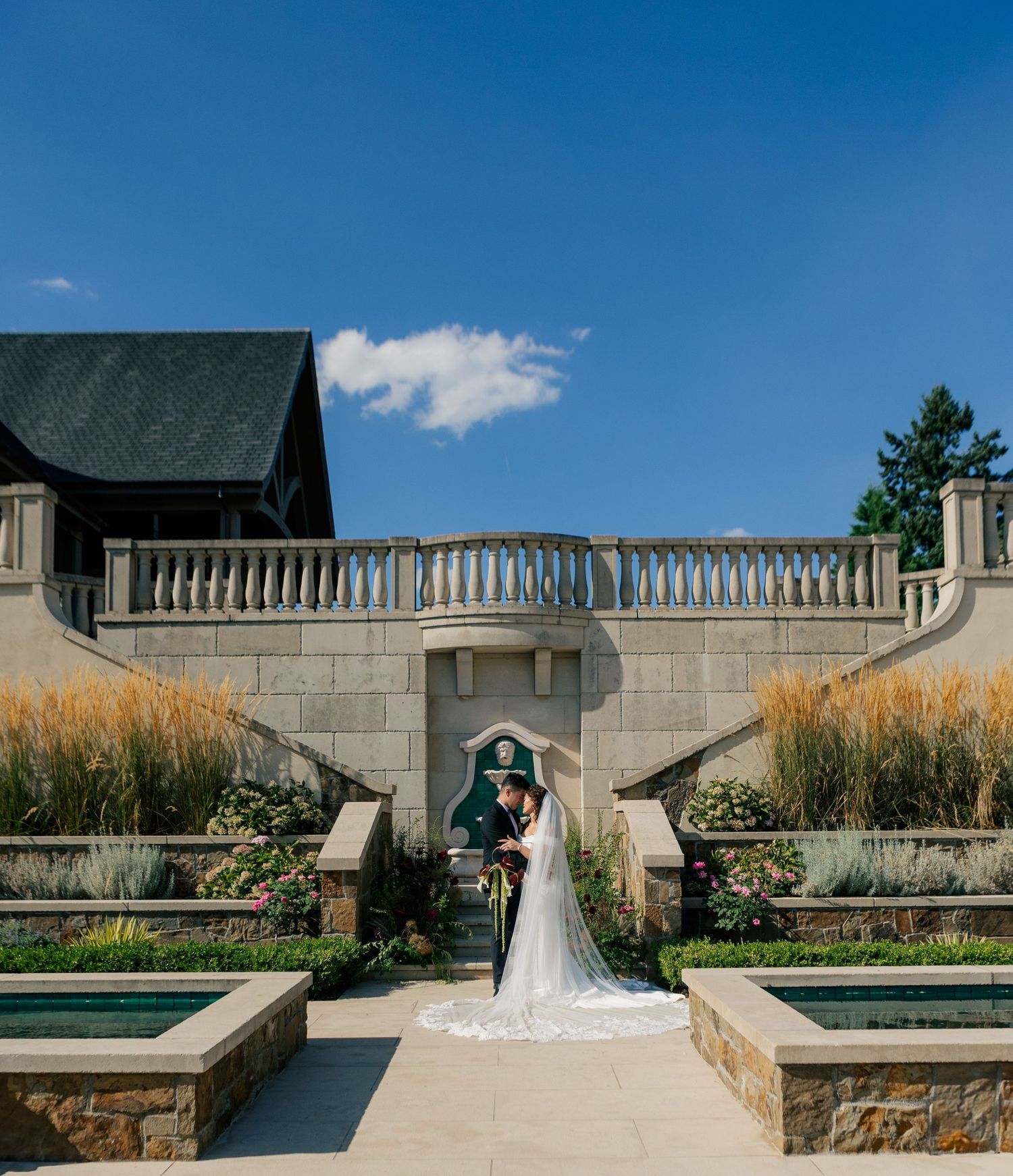 Cinematic wedding photography sequence showing couple walking along elegant stone garden terrace on sunny day.