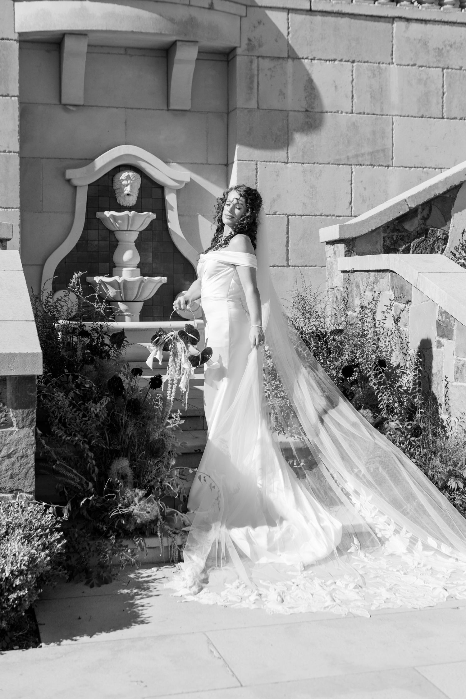 A sequence showing someone in a billowing white dress moving quickly across a building's exterior in dramatic motion.