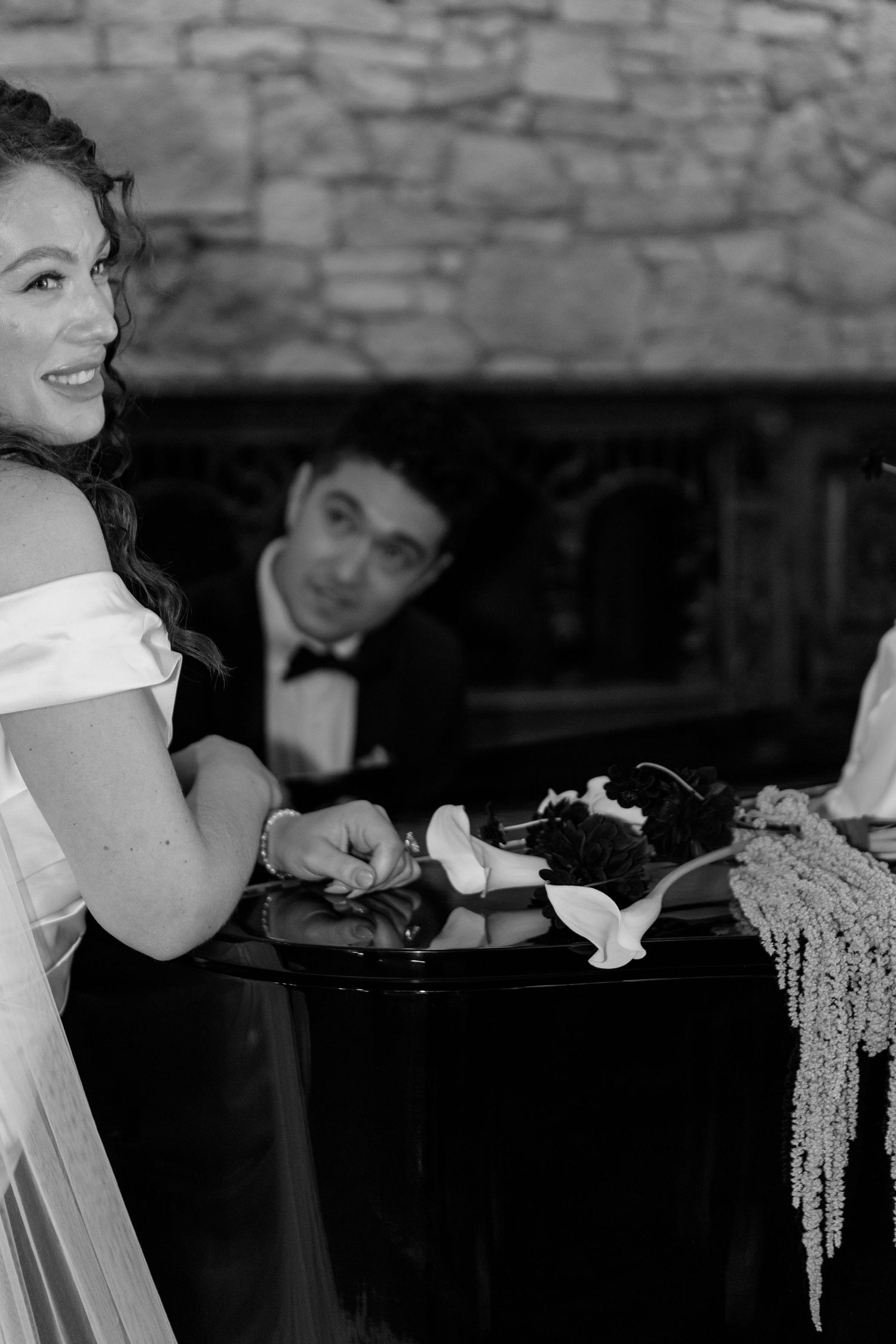 Black and white photo showing silhouettes of people dining at an elegant wedding reception.