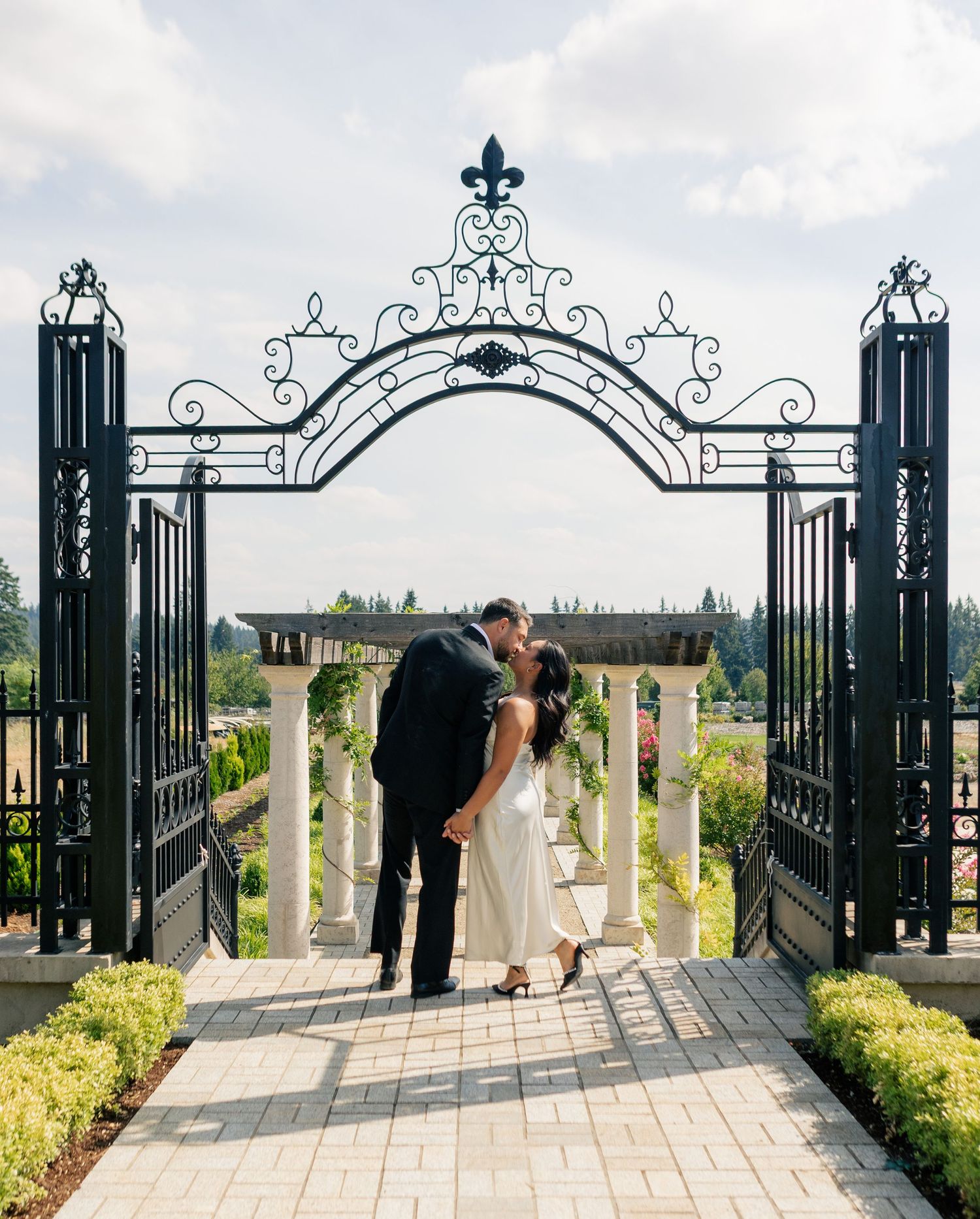 A series of romantic couple poses silhouetted against ornate metal gates and scenic countryside views.