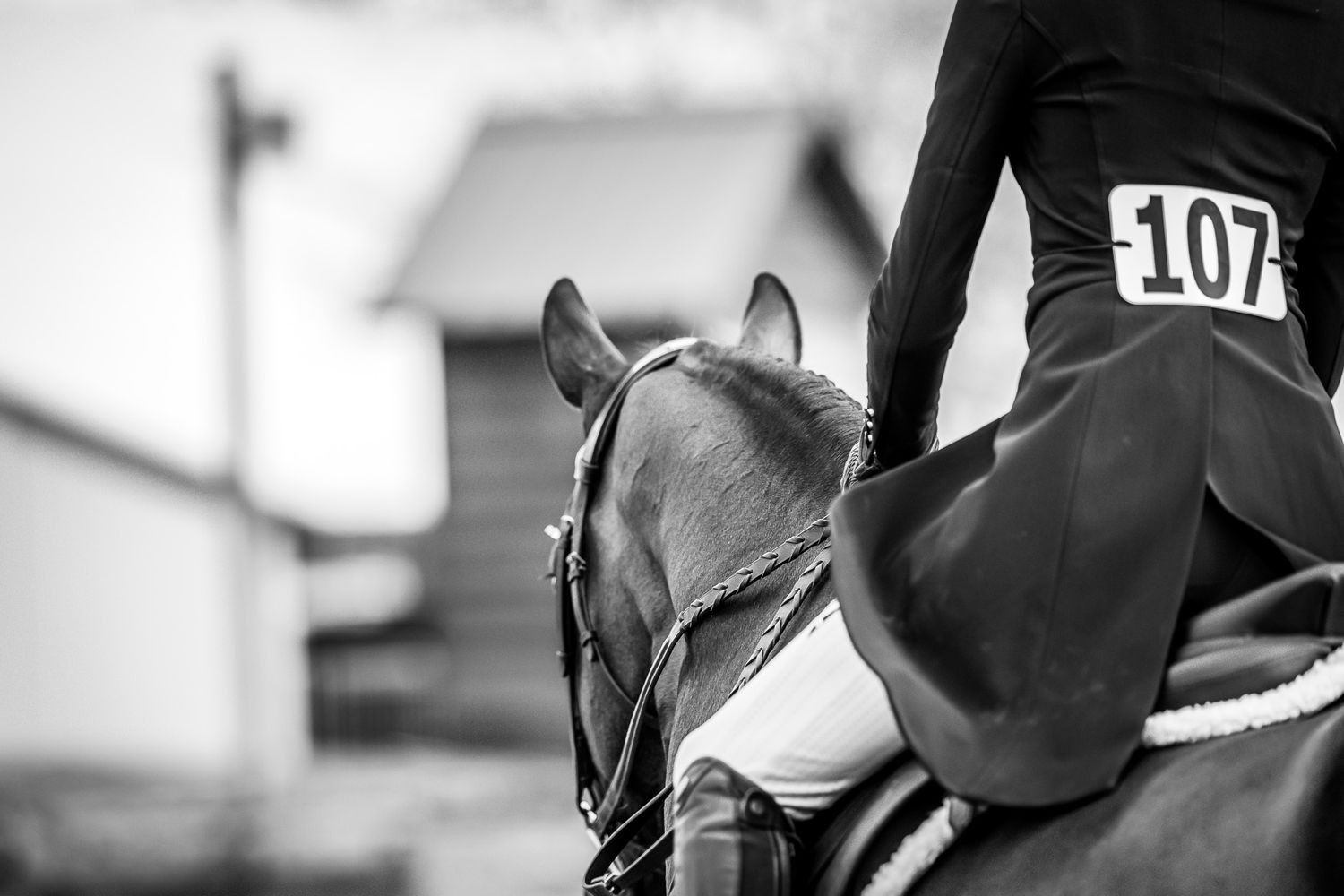 Young rider sharing a calm moment with her horse before entering the ring