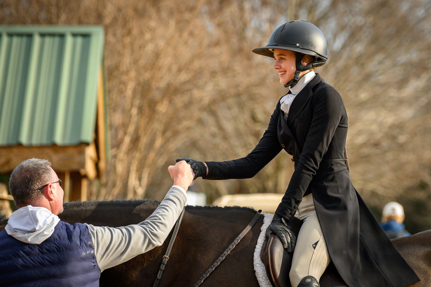 Horse show competitor smiling after learning she won her class in a Hunt & Go Derby.