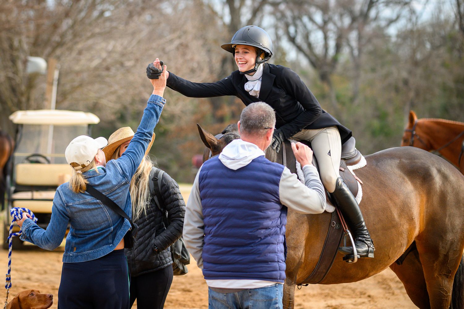 Rider celebrating a winning round with her horse and family at Texas Rose Horse Park taken by private show photographer Sean Stacey.
