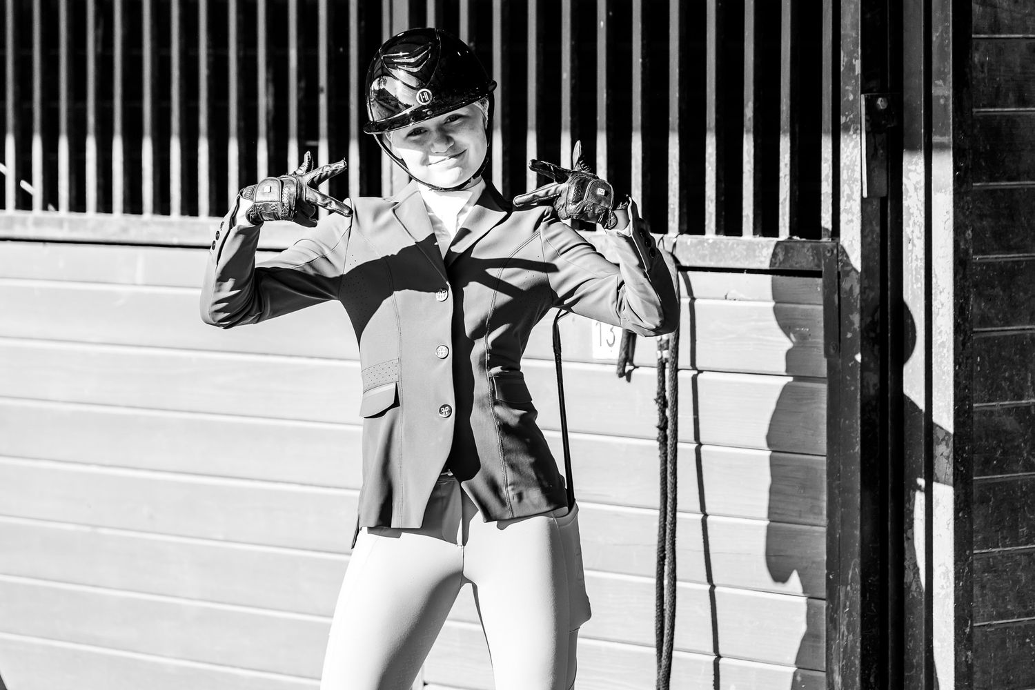 A young equestrian posing back at the barn as she prepares for an upcoming jumper competition at Texas Rose Horse Park.