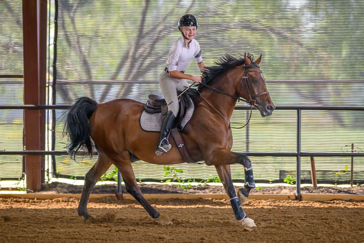 Smiling equestrian rider patting horse after clear round — emotional moment captured by professional photographer.