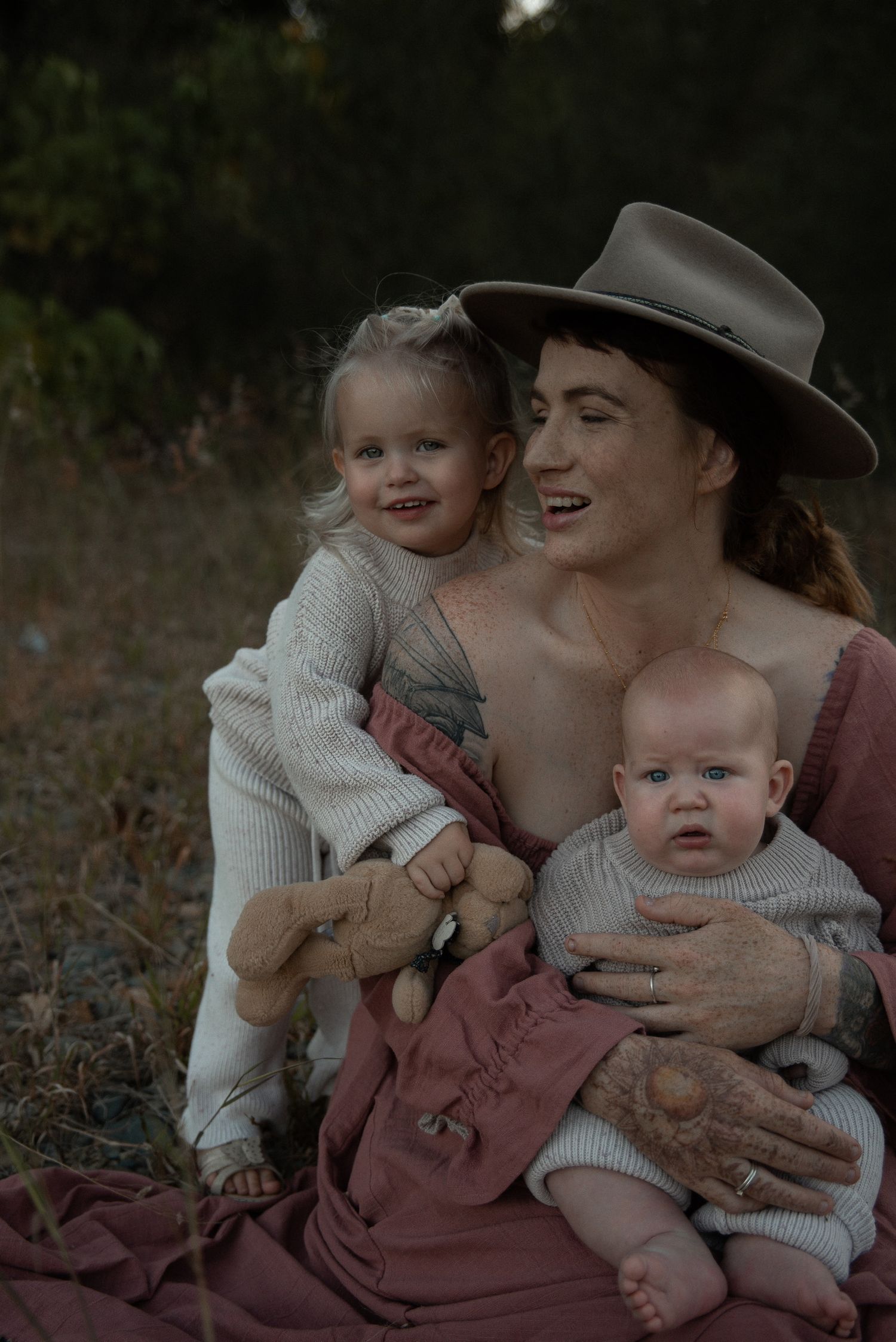 A tender outdoor family portrait in vintage style clothing.