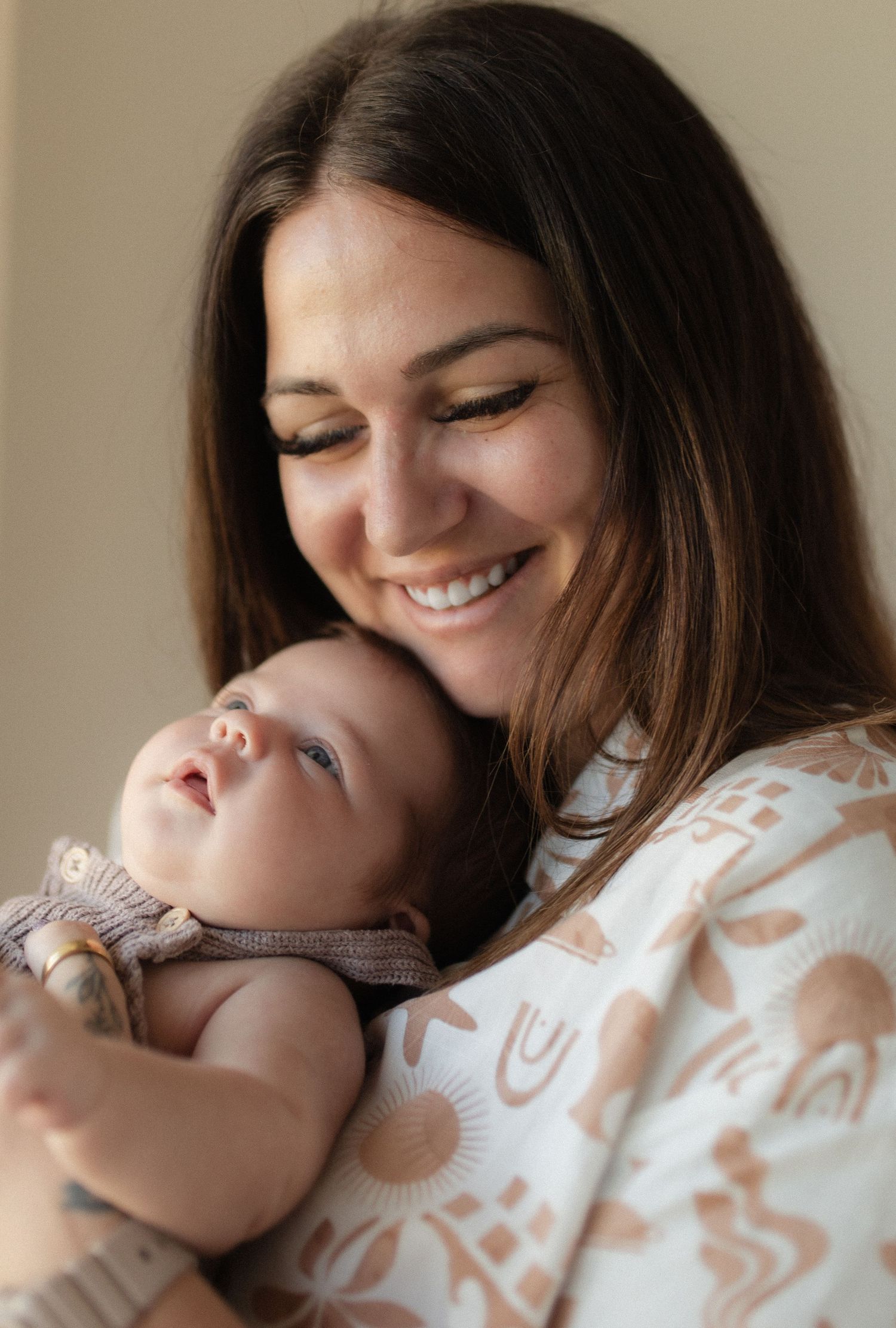 Intimate portrait of mother and baby sharing a loving moment in natural light.