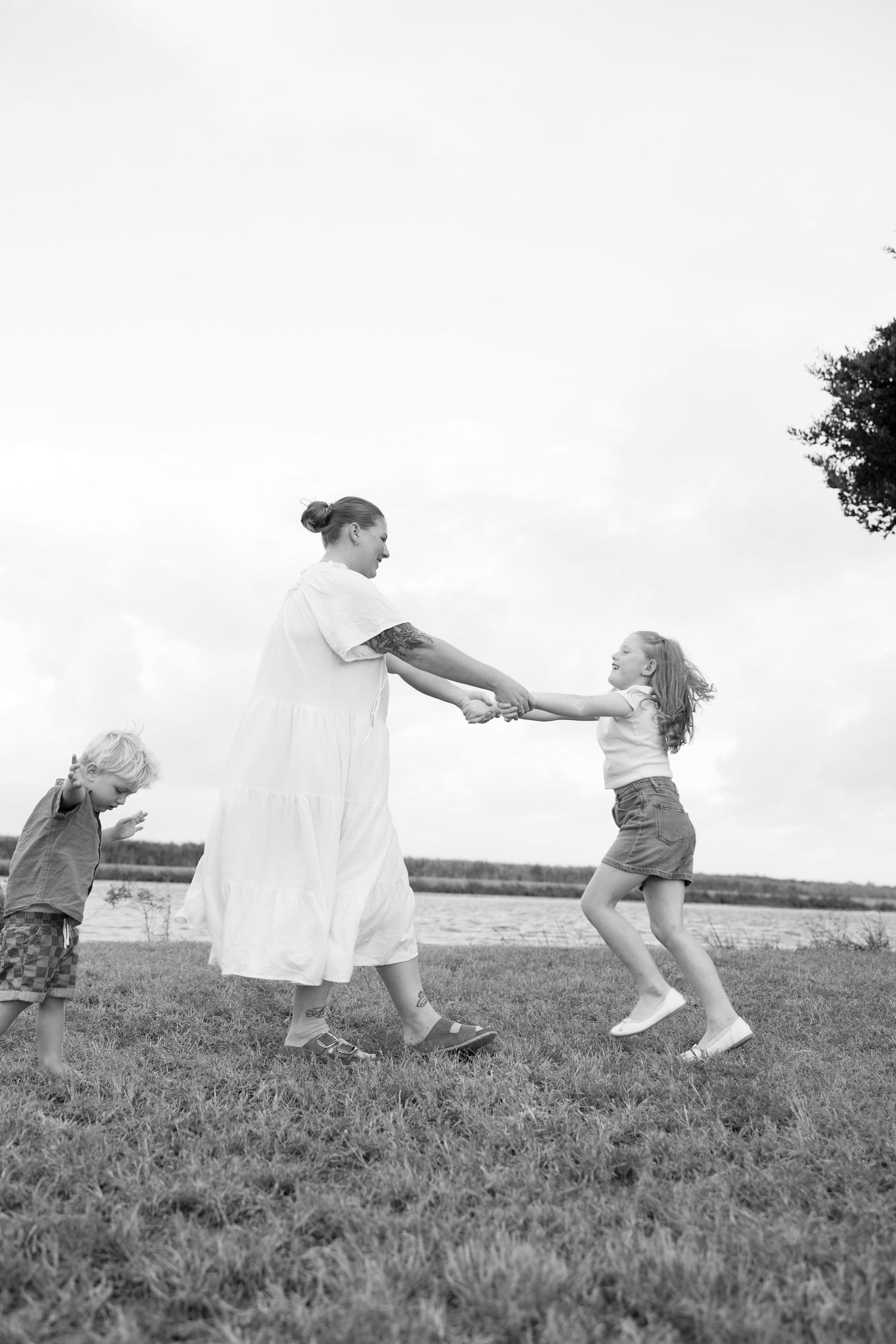 A joyful spinning dance moment between figures in a grassy field.
