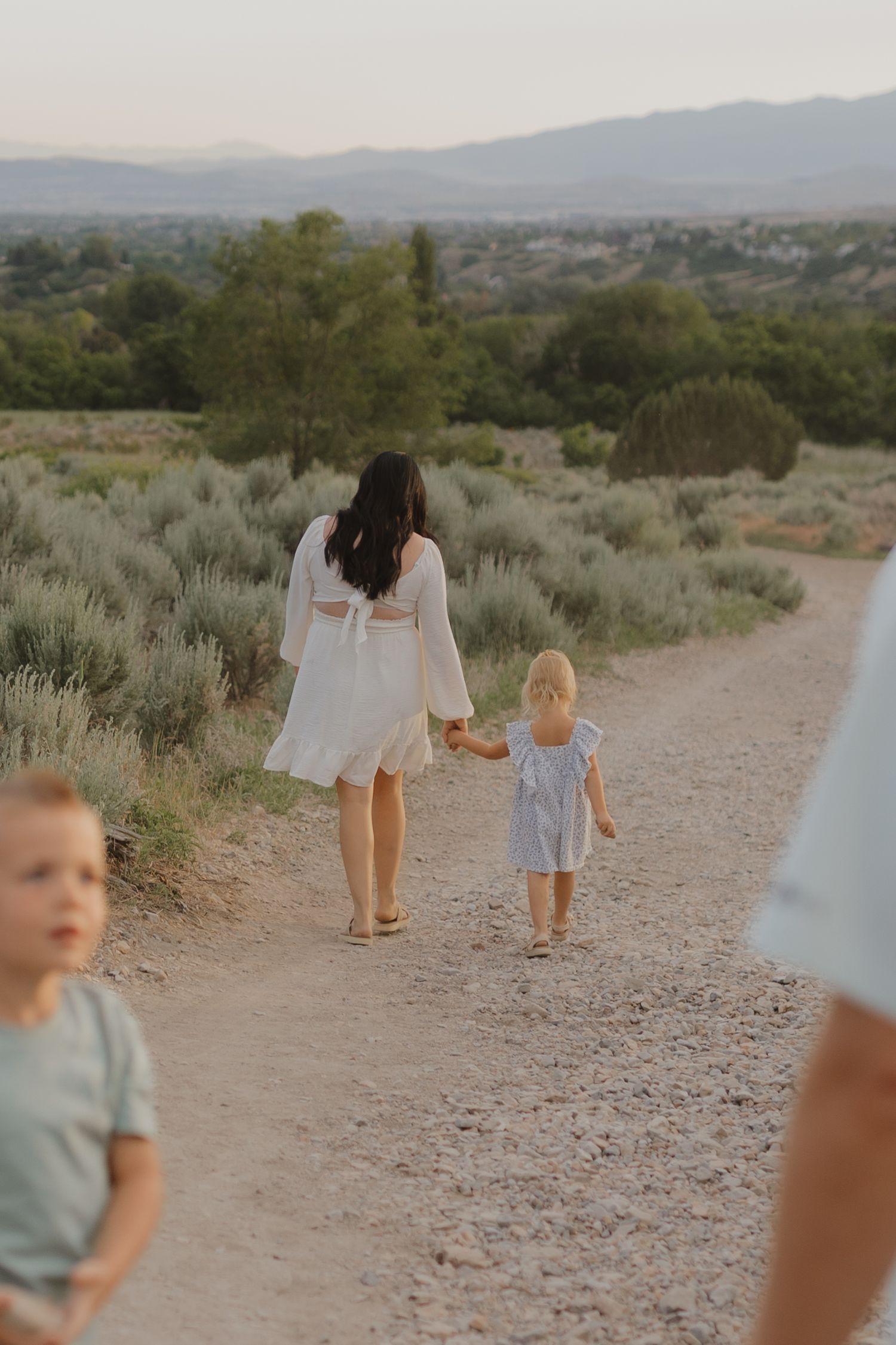 family walking down path during an outdoor family session in utah in the mountains