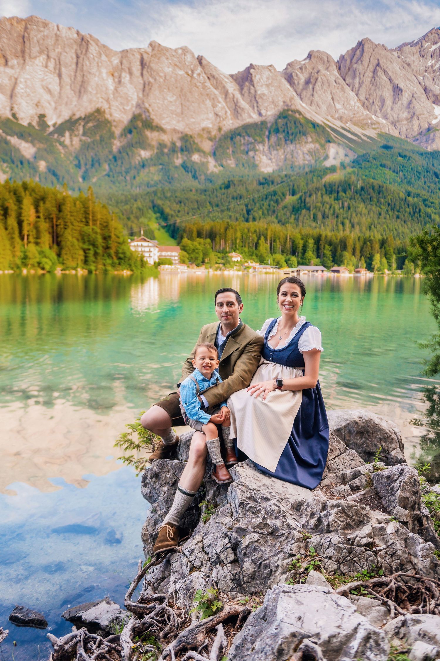 Scenic lake surrounded by majestic mountains with turquoise waters reflecting the rocky peaks and alpine landscape in the background.