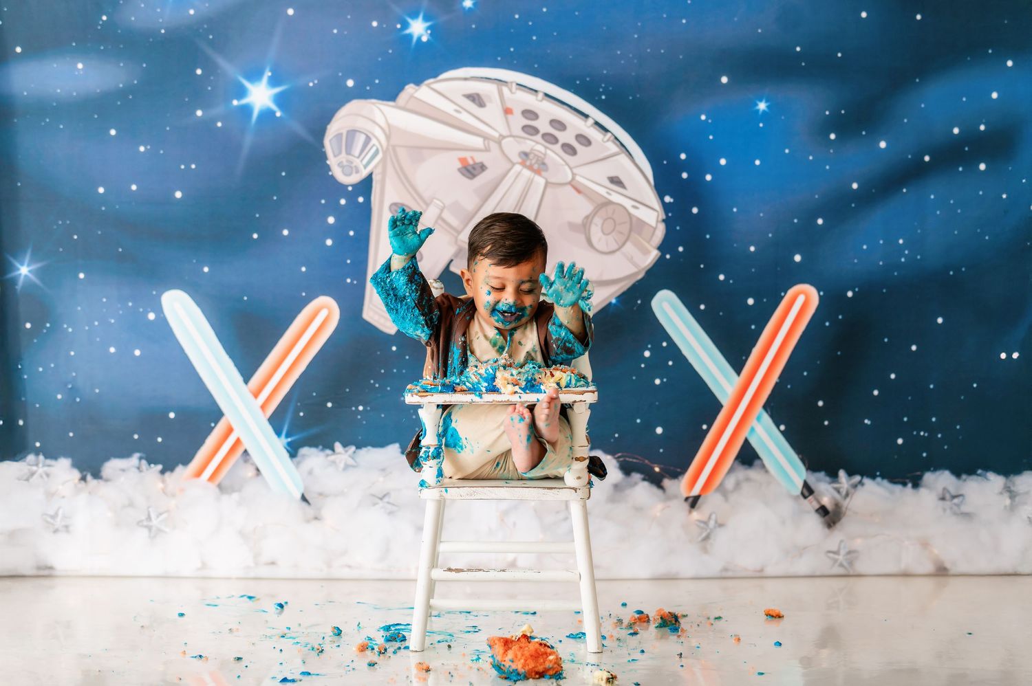 A person wearing a blue sweater works at a desk with a laptop and Christmas decorations in a snowy winter scene.