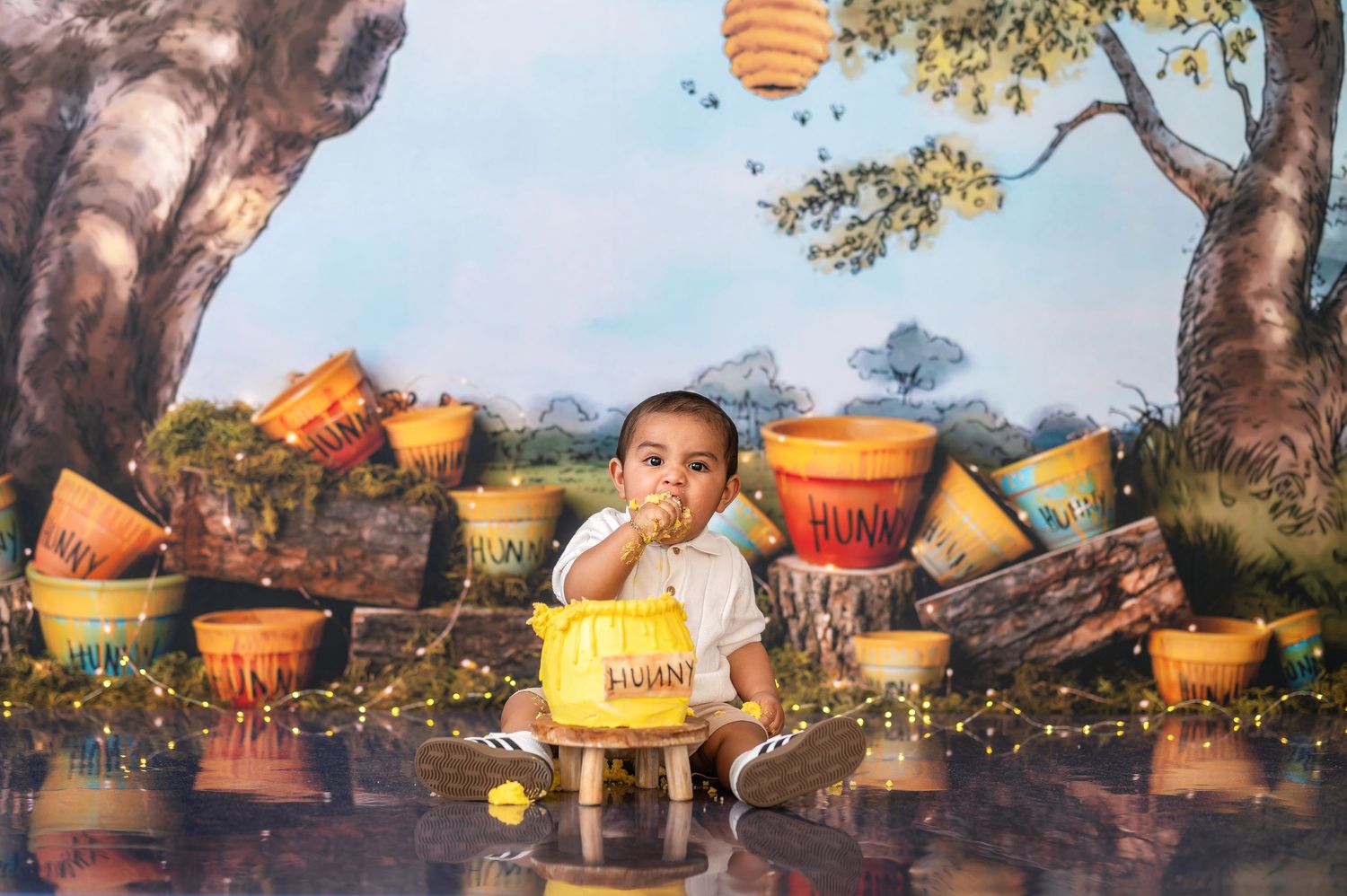 Honey themed cake smash photography session with golden lighting and natural outdoor setting.