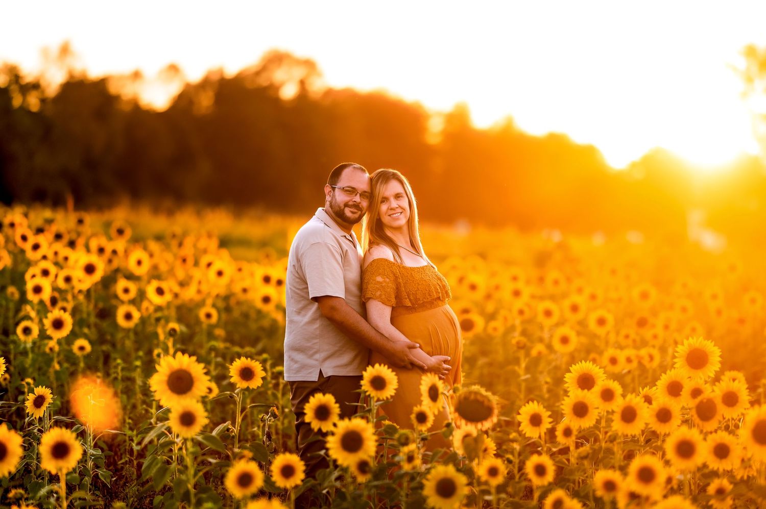 Romantic sunset photoshoot in a vibrant field of blooming sunflowers.