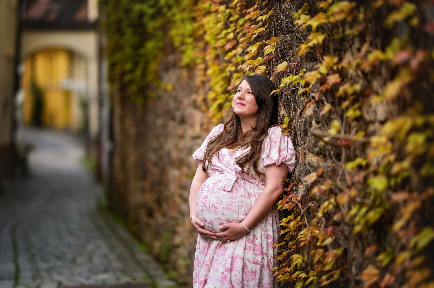 Series of romantic maternity photos against an ivy-covered stone wall.