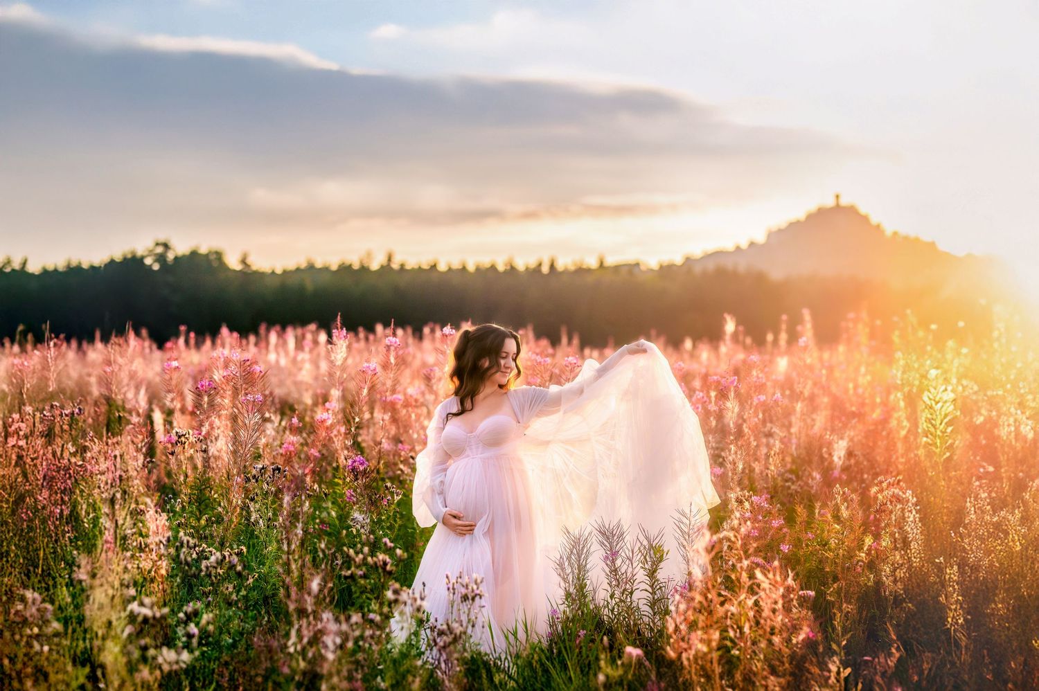 Ethereal figure in flowing white dress stands among pink wildflowers at sunset in a dreamy meadow landscape.
