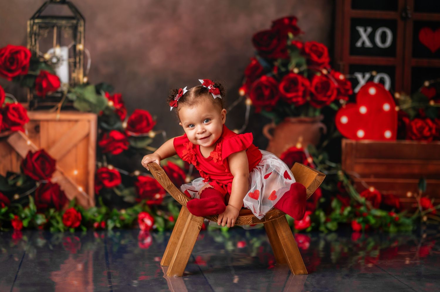 Romantic red rose Valentine's day themed photo setup with vintage decorations.