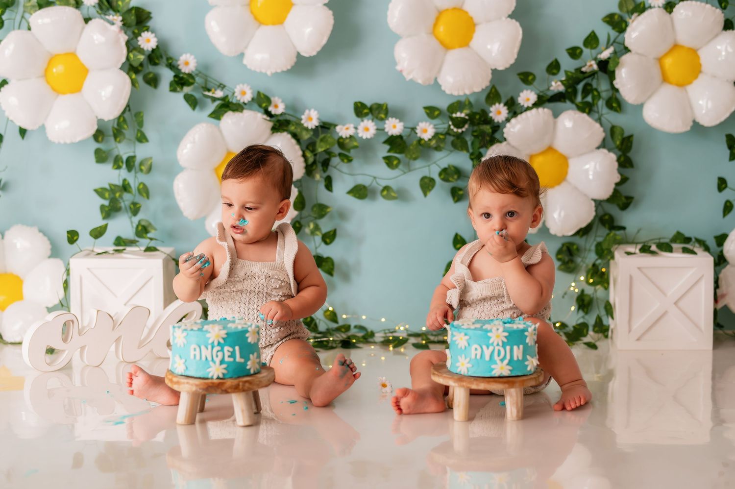 Milestone photography setup with floral backdrop and decorative lettering.