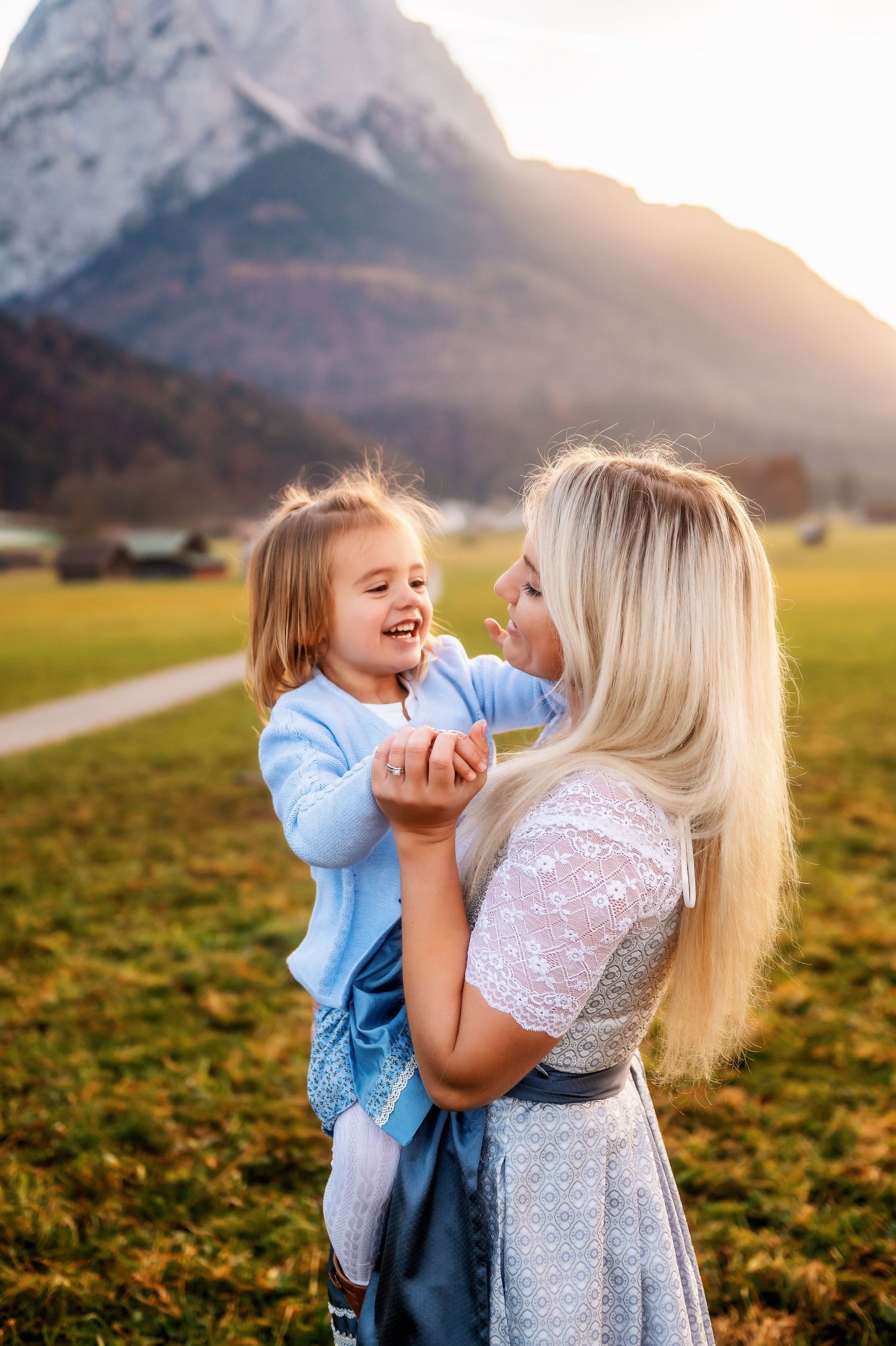 A heartwarming series of candid shots showing joyful interactions in a scenic mountain meadow at sunset.