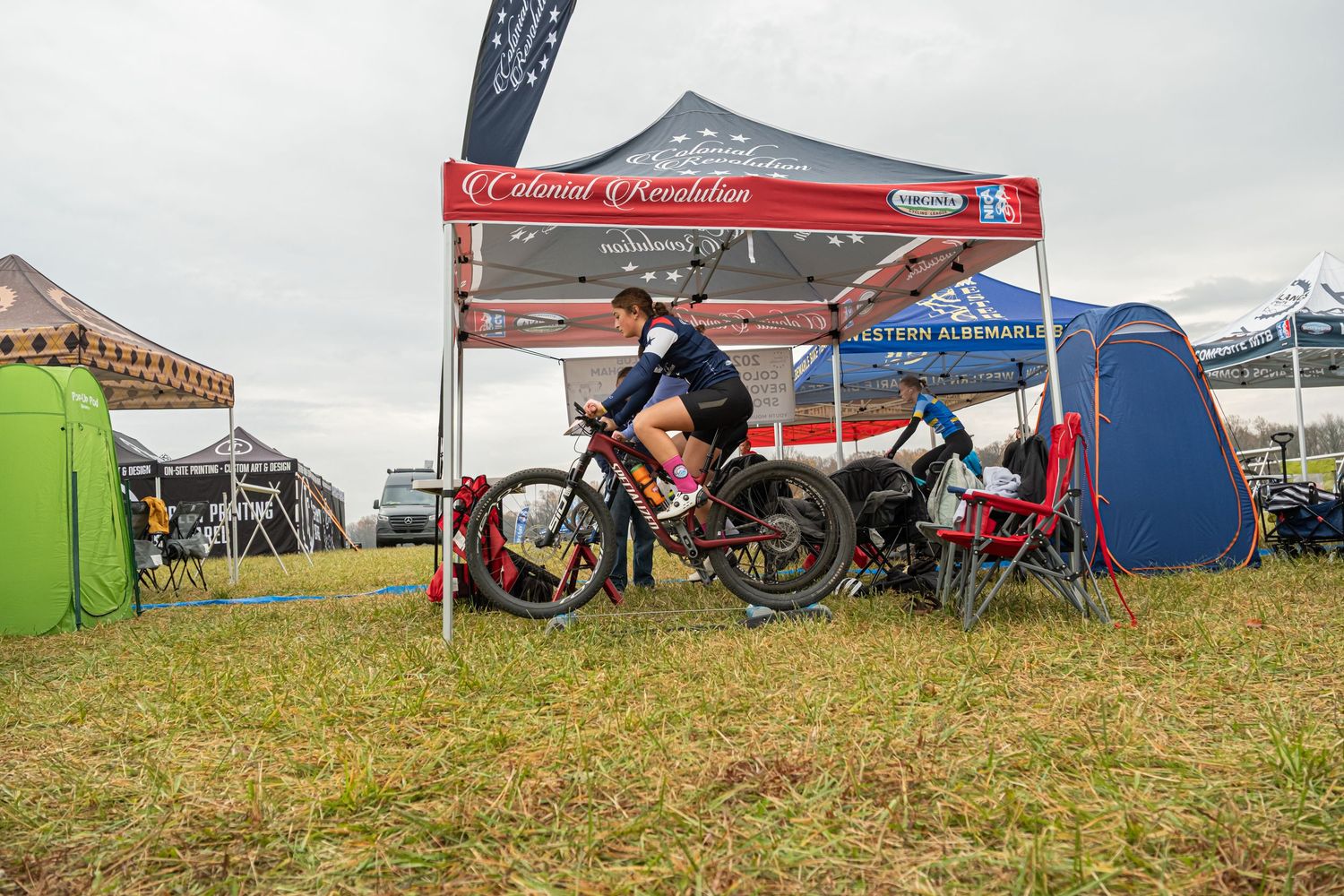Colonial Revolution rider on bike rolers warming up for NICA mountain bike race