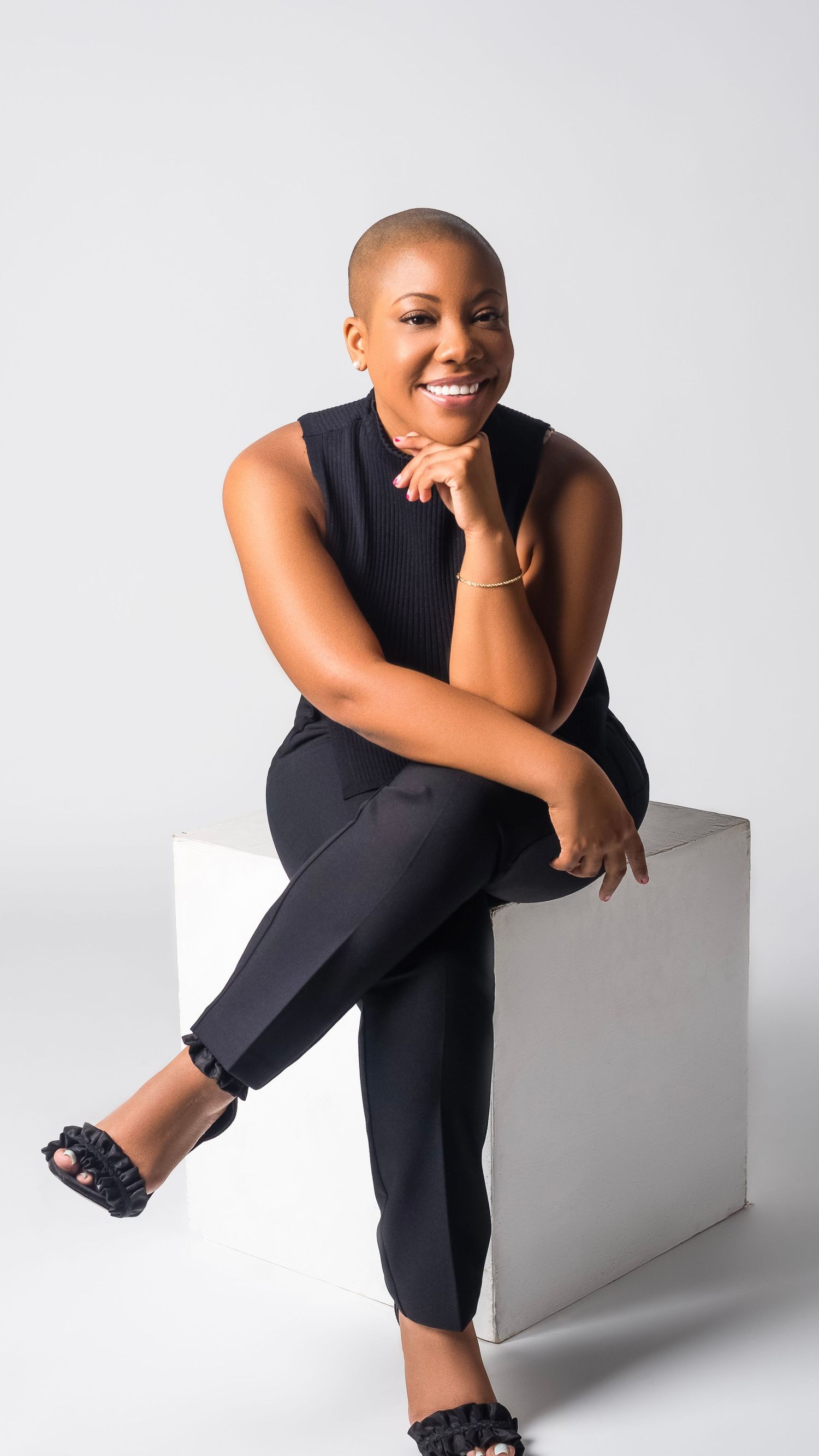 Professional studio portraits showing different casual seated poses against a white backdrop.