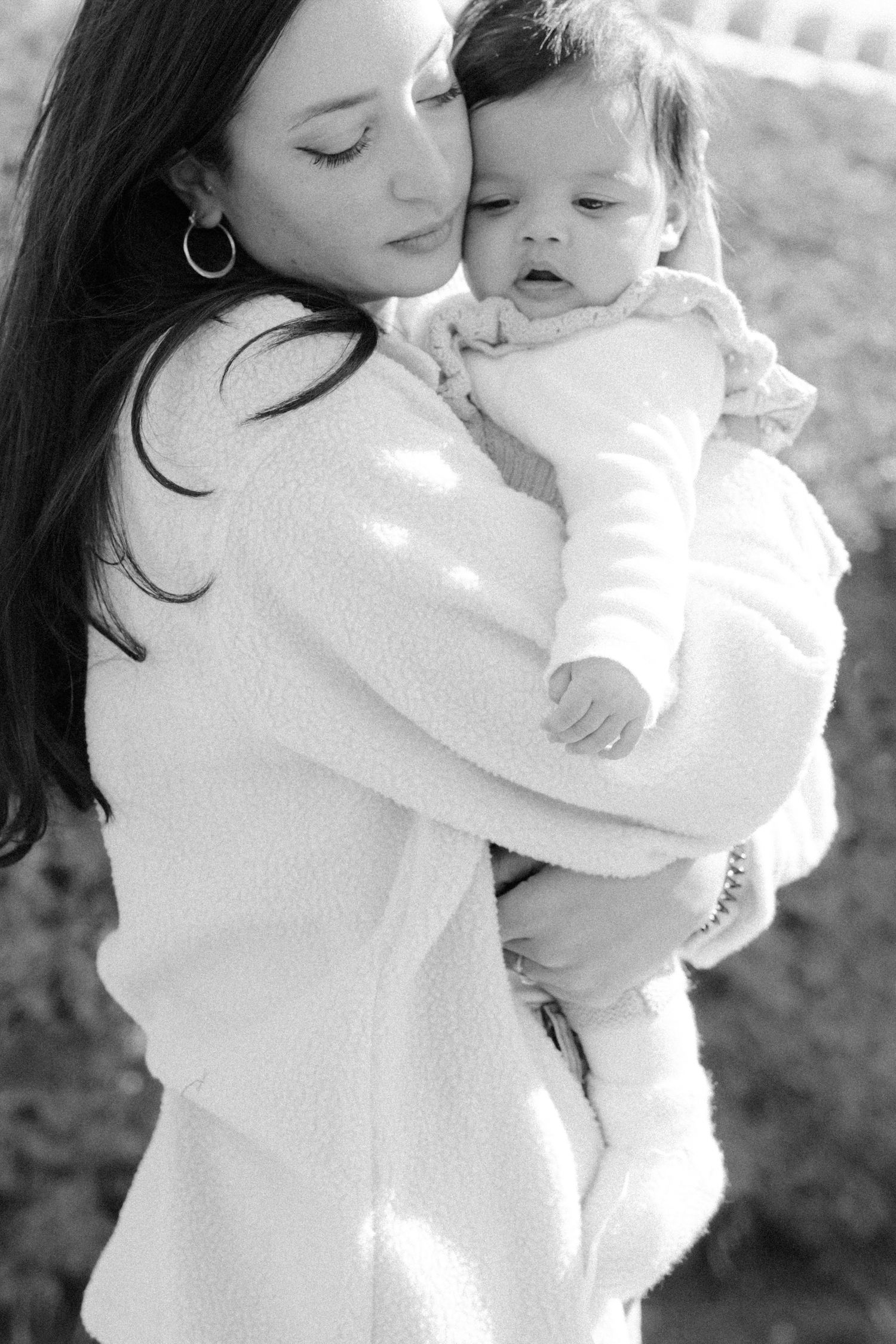Intimate black and white portraits capturing tender family moments in natural light.