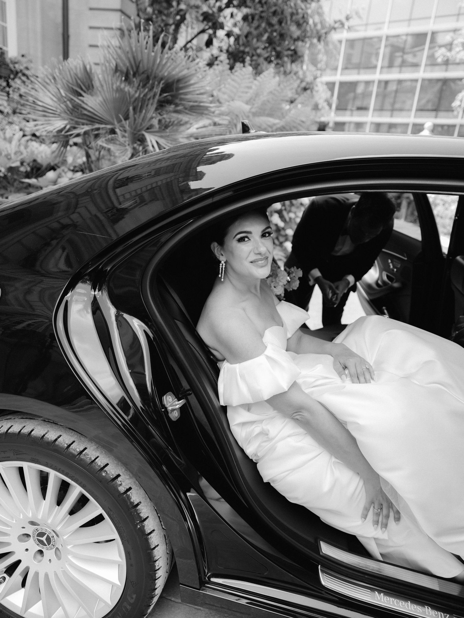 A series of black and white photos showing a bride in a white dress sitting elegantly in a luxury car.