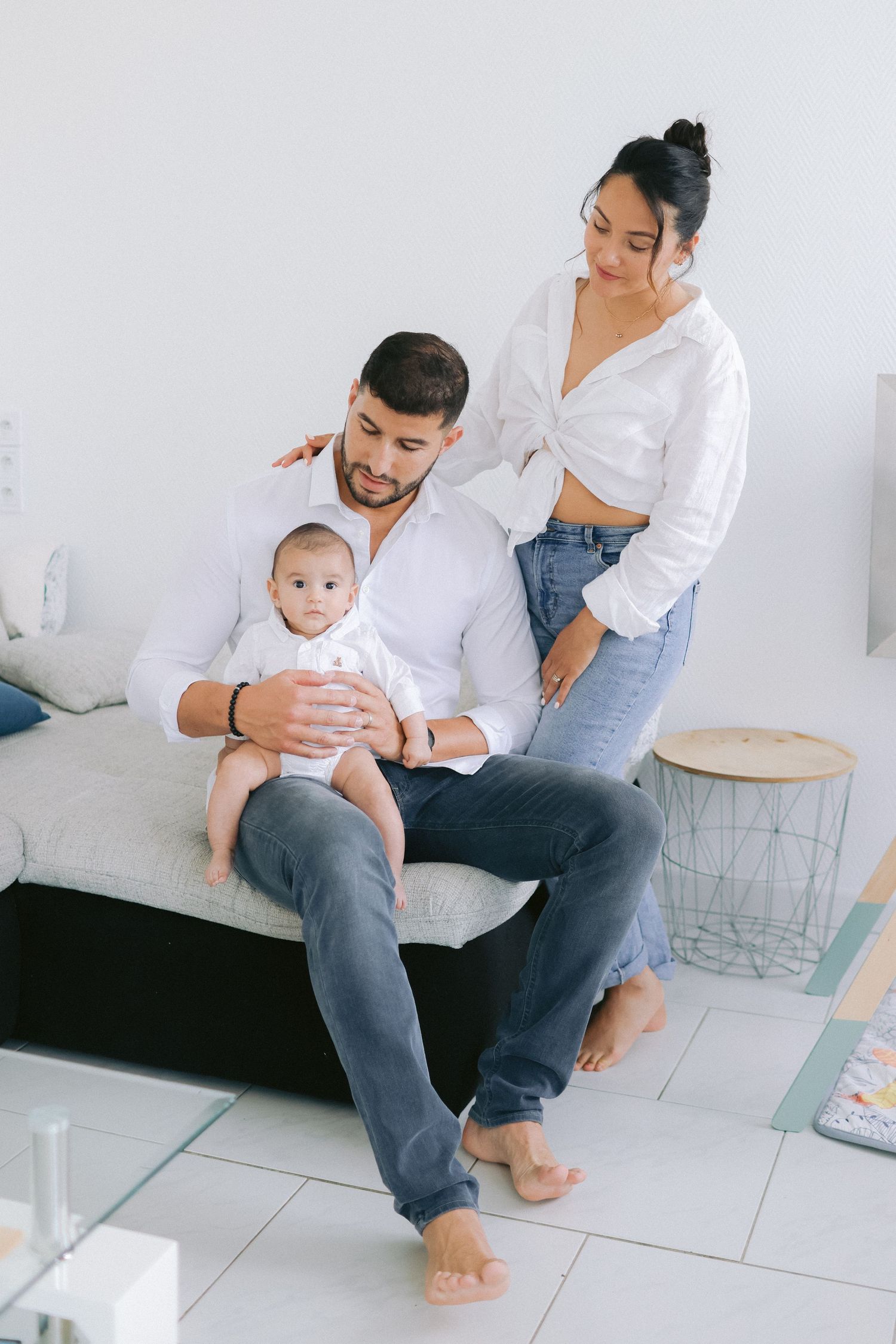 Family sharing tender moments on white tiled floor.