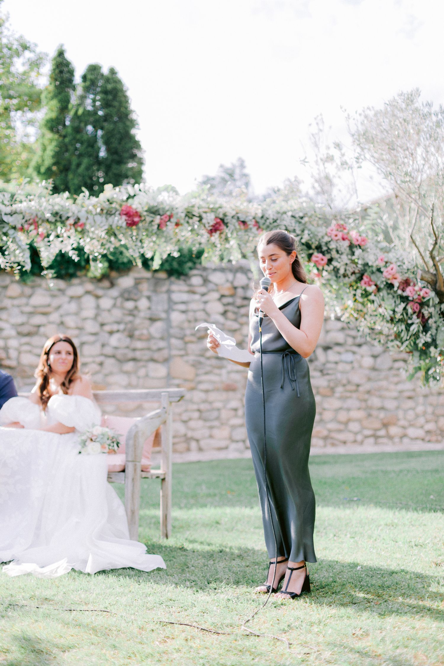 Wedding celebration moments captured against a stone wall backdrop in an outdoor garden setting.
