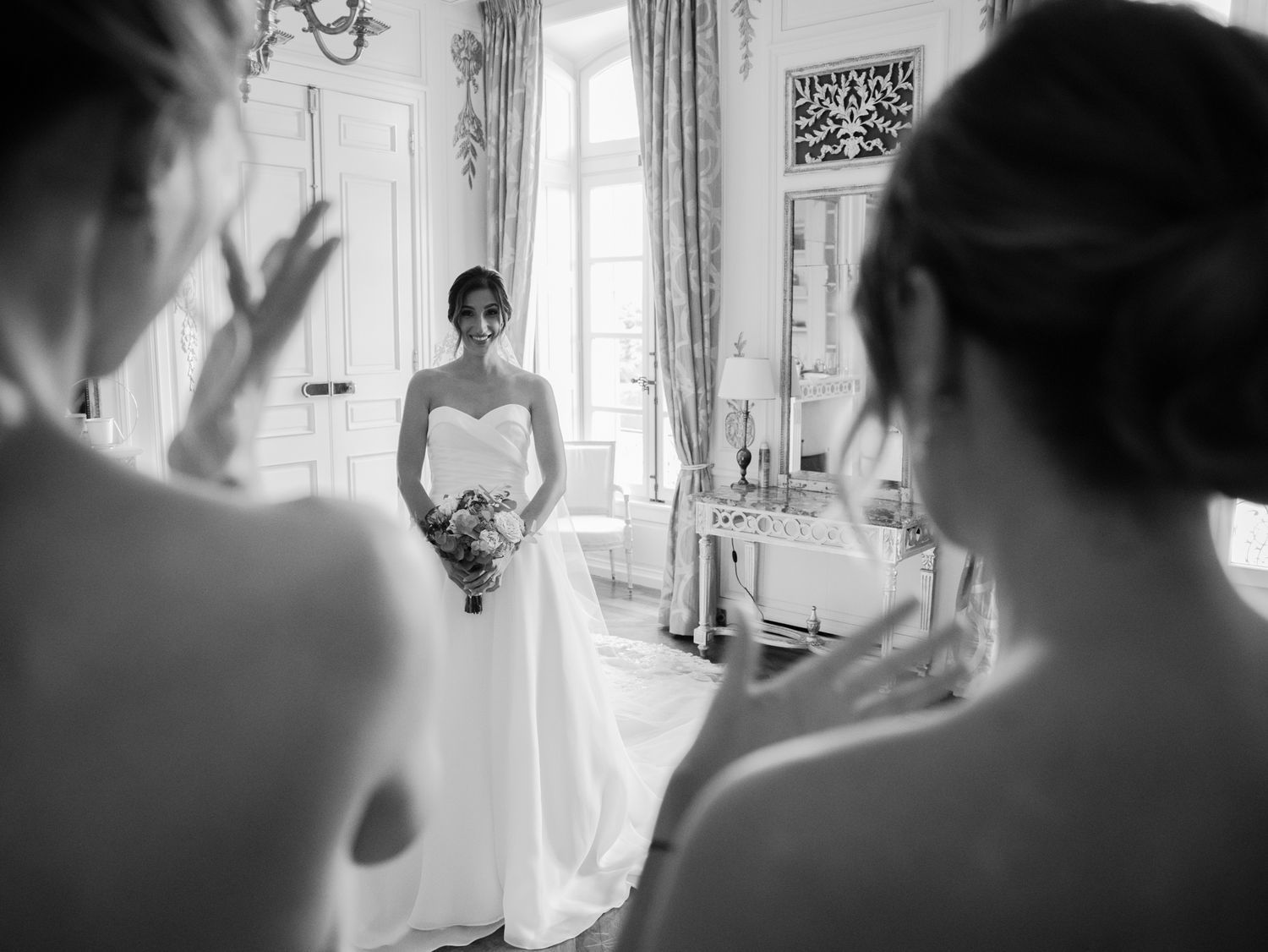 Soft focus wedding preparation scene through vintage window reflections.