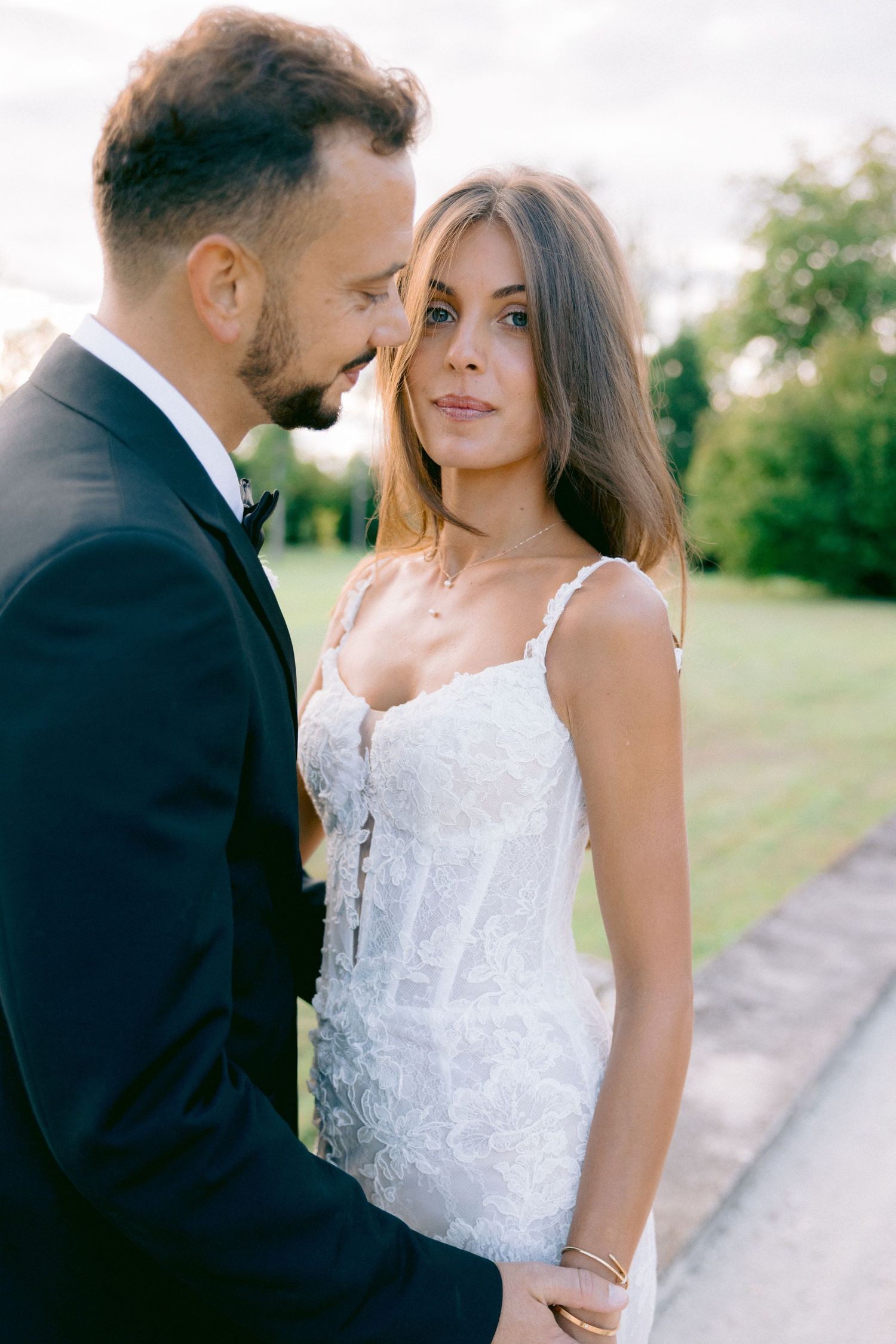 Romantic close-up wedding portrait with soft lighting and natural backdrop.