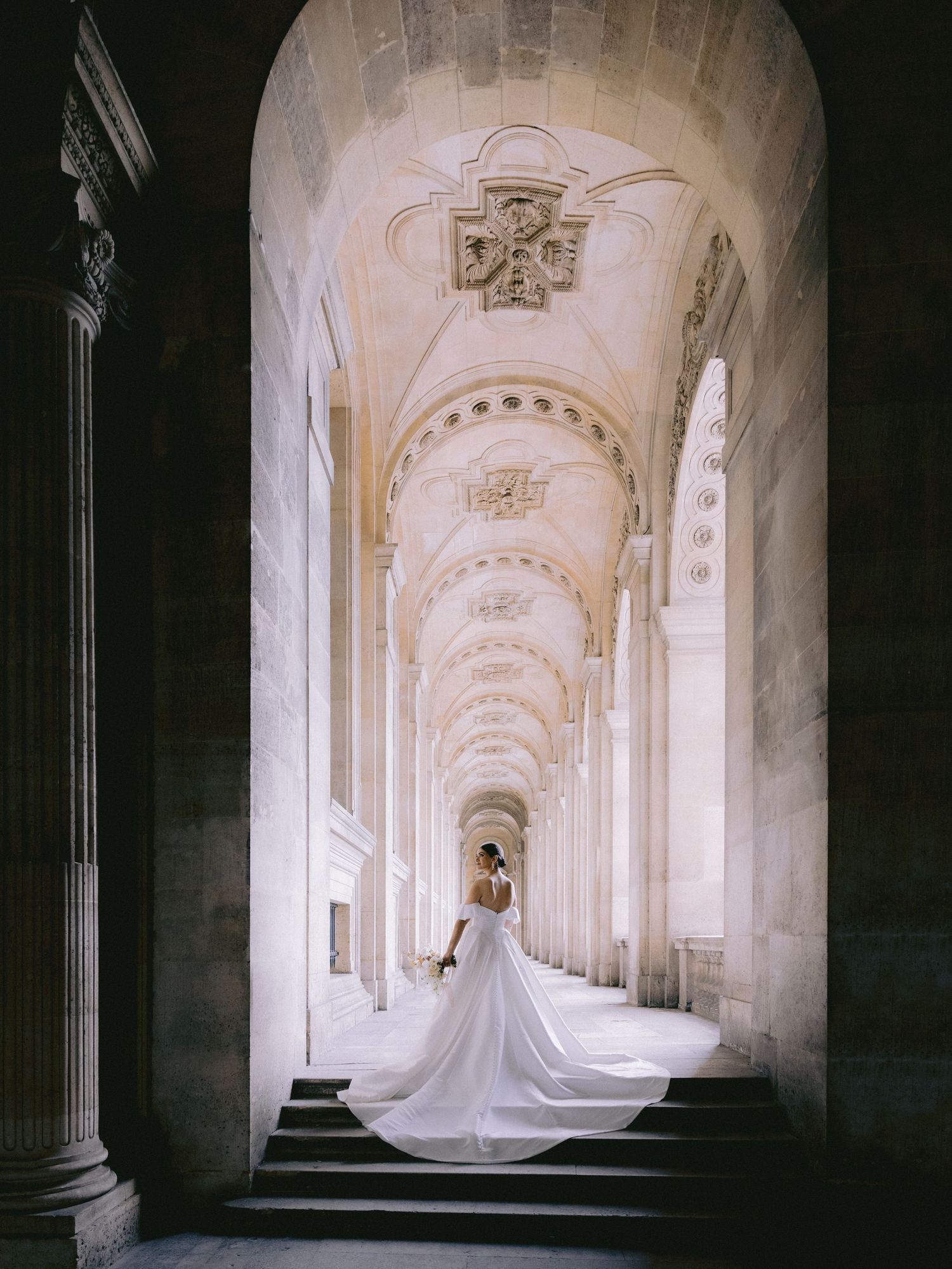Bride photographed at the Louvre during an intimate wedding in Paris