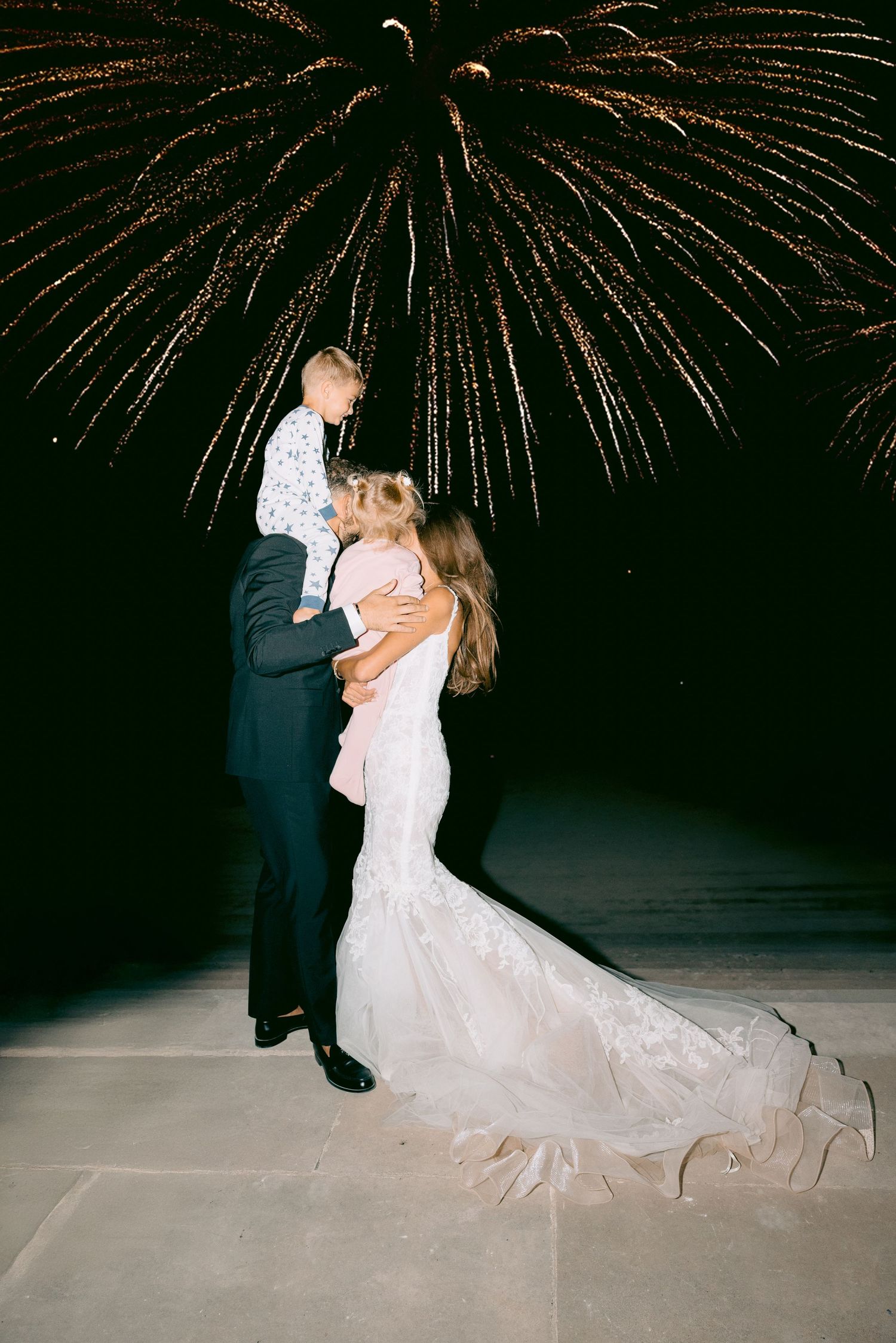A couple shares a romantic dance under spectacular fireworks during their wedding celebration at Château de Sept Saulx
