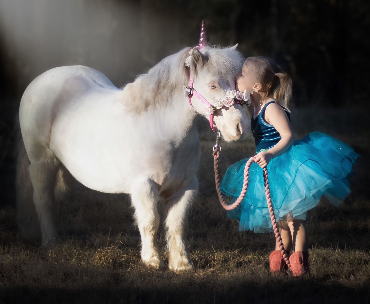 A whimsical portrait of a white pony and blue tutu dress creates a magical fairytale scene.
