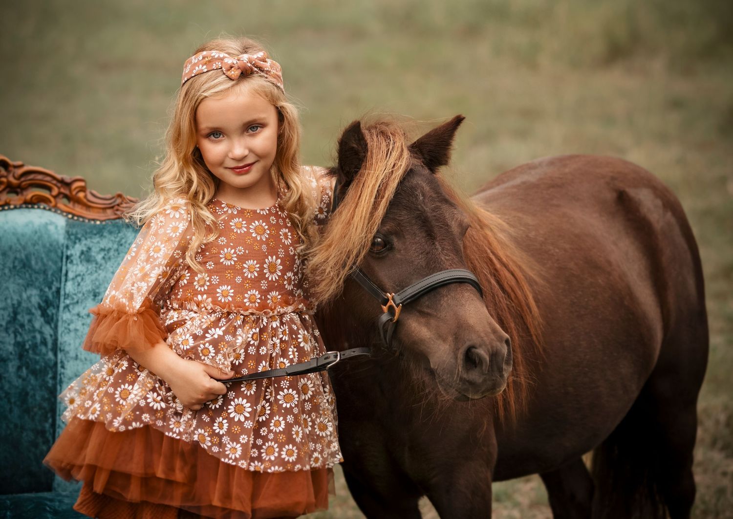 A heartwarming scene with a brown horse and someone sitting on a teal vintage couch.