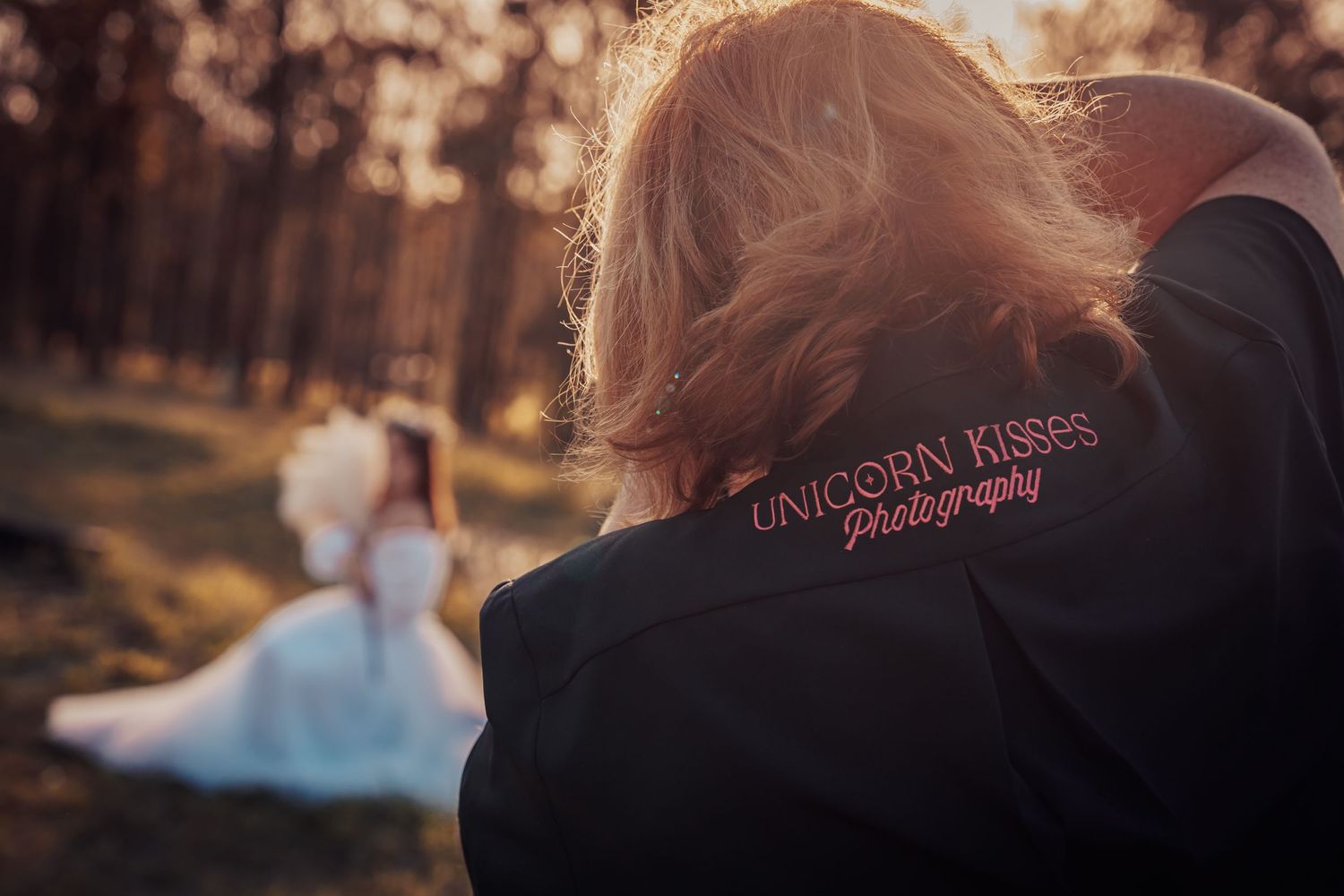 Behind-the-scenes shot of a photographer at work during a sunset wedding photoshoot.