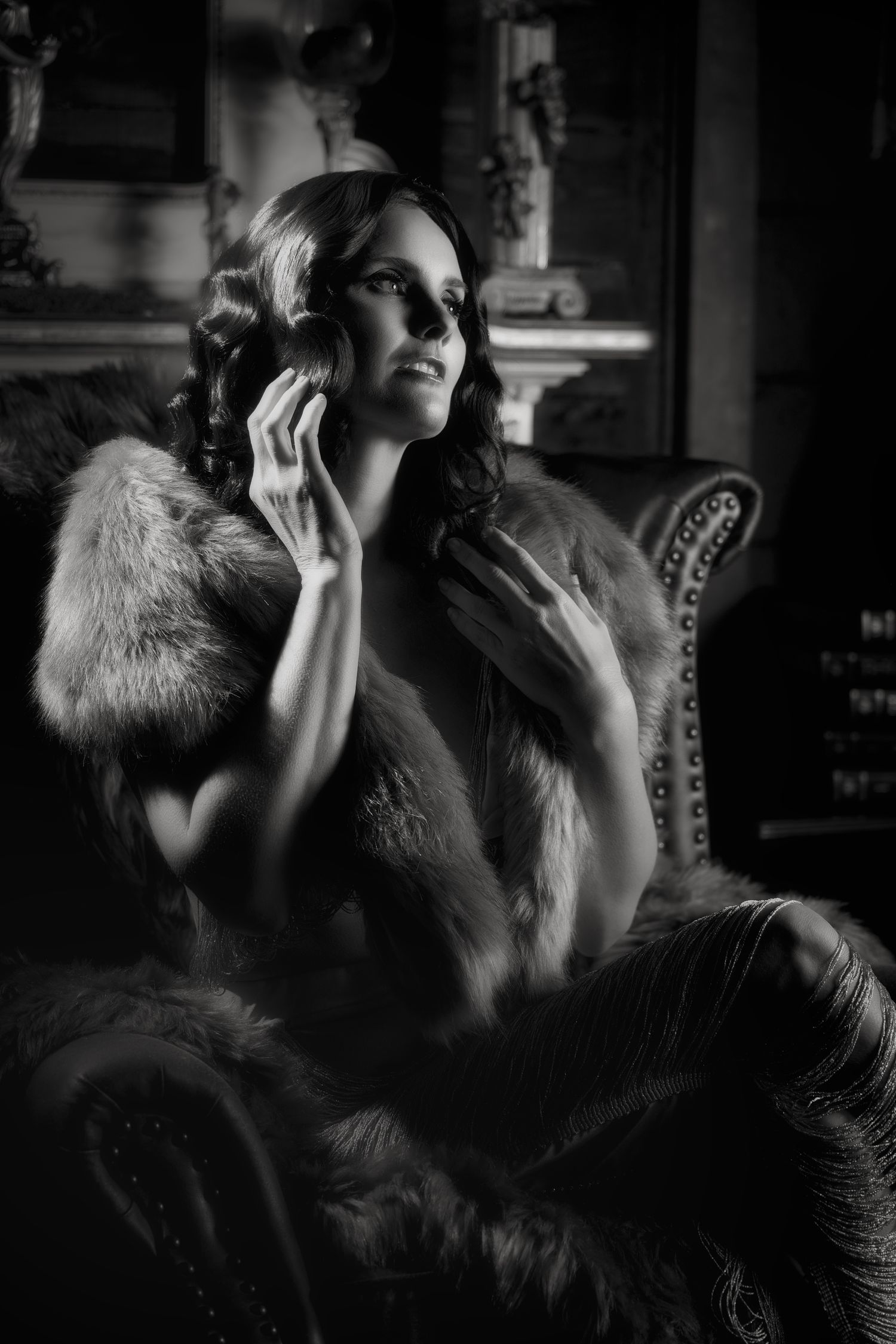 Dramatic black and white photo series showing a person in vintage glamour style with fur stole posing against dark background.