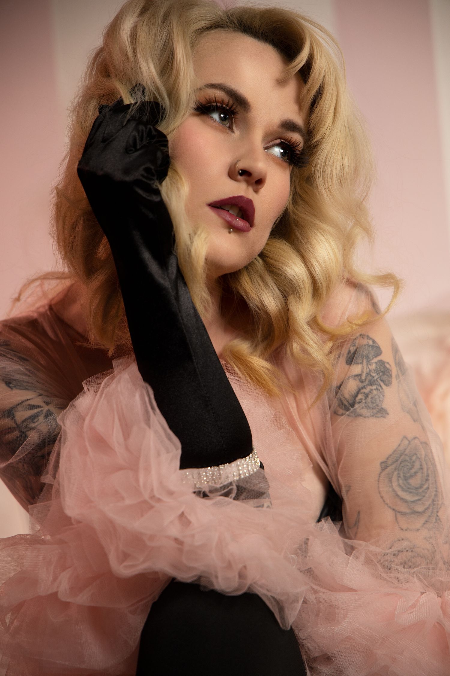 A series of glamour portraits featuring blonde hair, black gloves, and pink tulle fabric in a romantic boudoir setting.