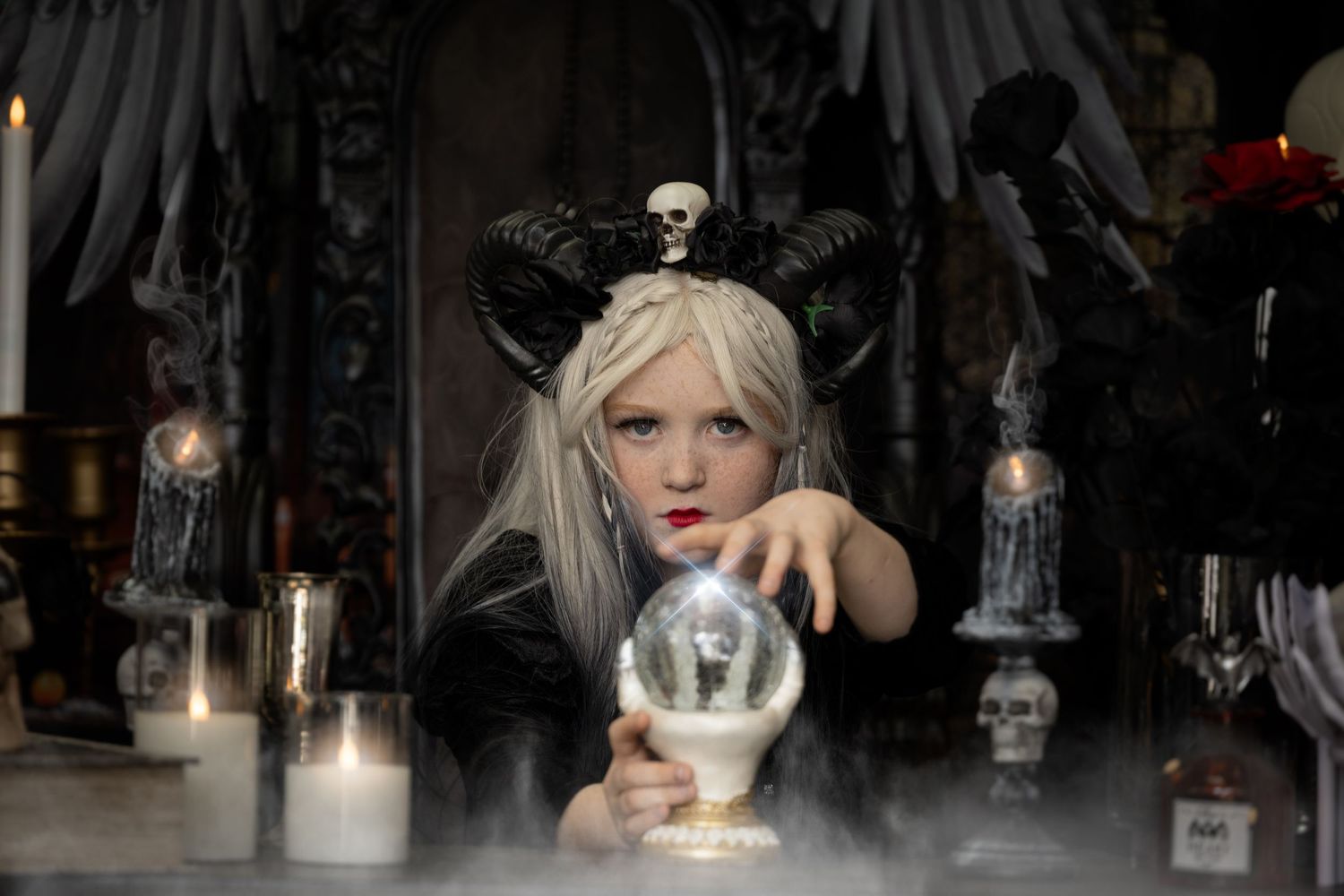 A dark and moody fashion show runway with dramatic lighting and gothic-inspired decor creates an ethereal atmosphere.