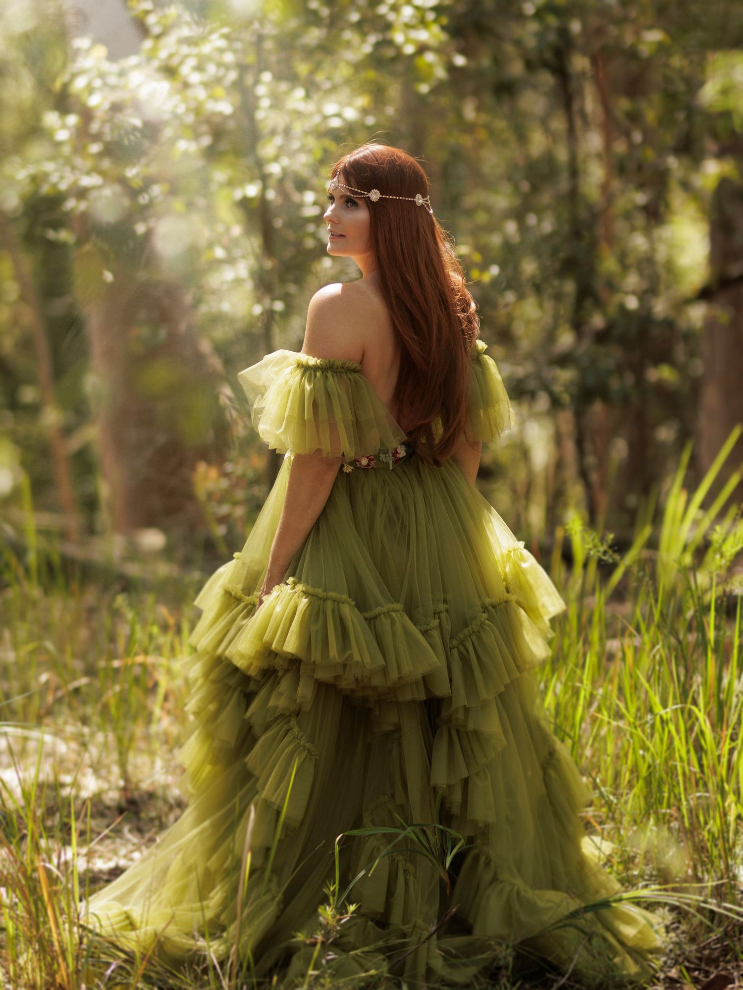 Flowing lime green tulle gown with ruffled layers captured in a dreamy forest setting.
