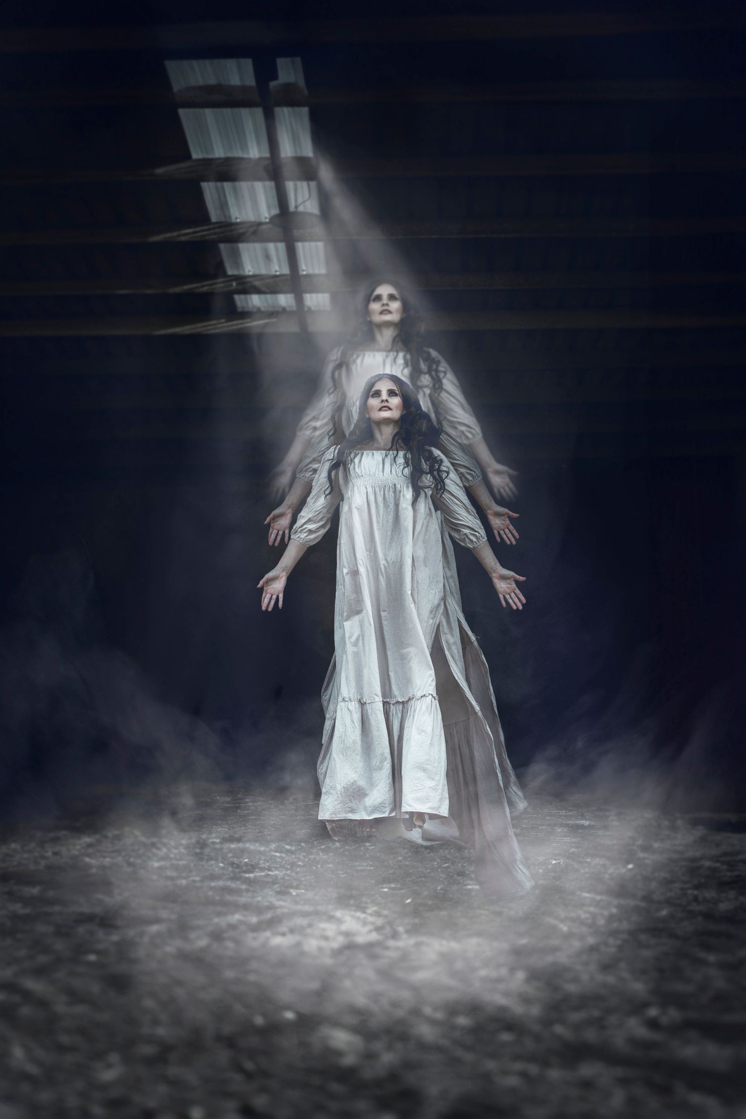 Haunting double exposure of figures in white dresses with dramatic lighting and fog effects.