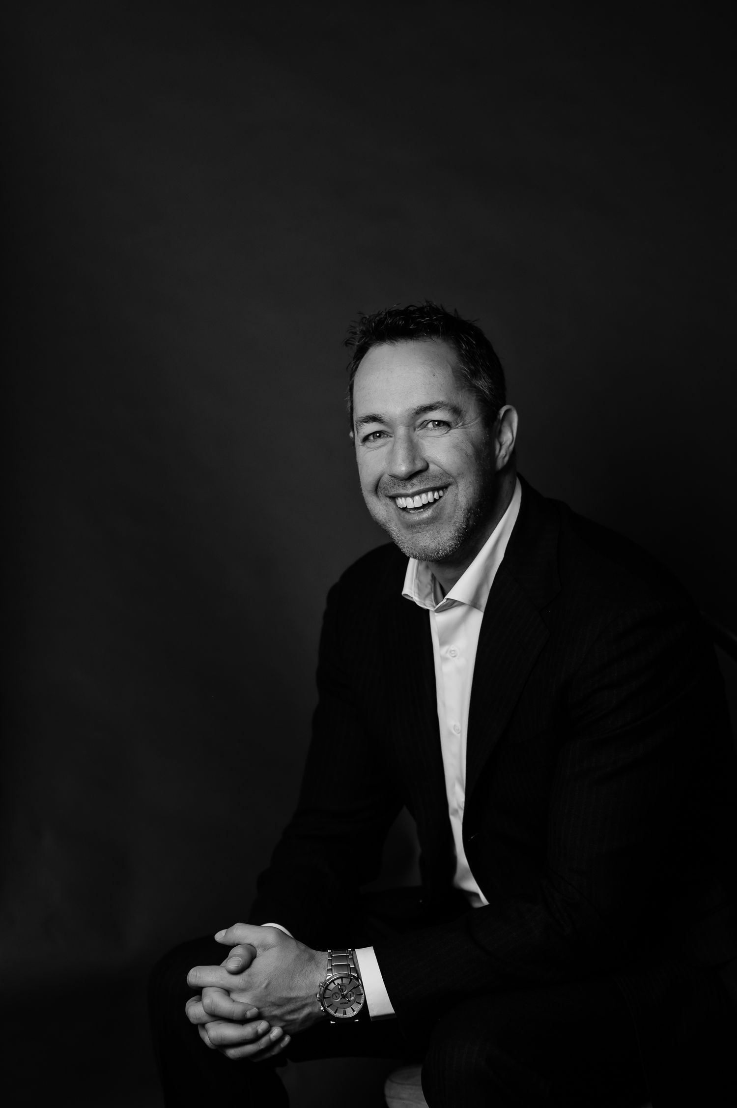 Black and white portrait series showing dramatic lighting and expressions against a dark background.