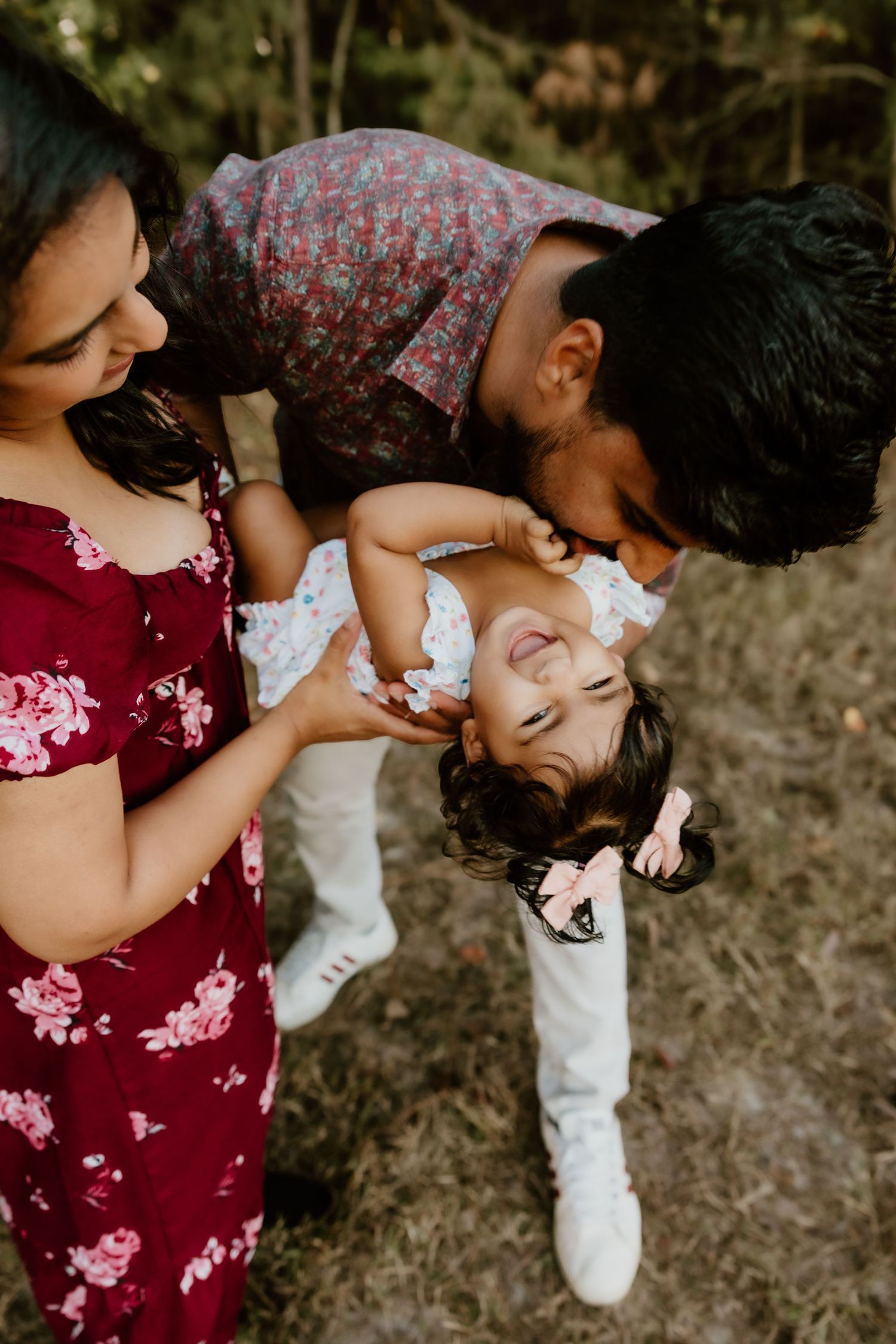 A series of candid shots showing tender moments between a parent and baby in matching burgundy and white outfits.