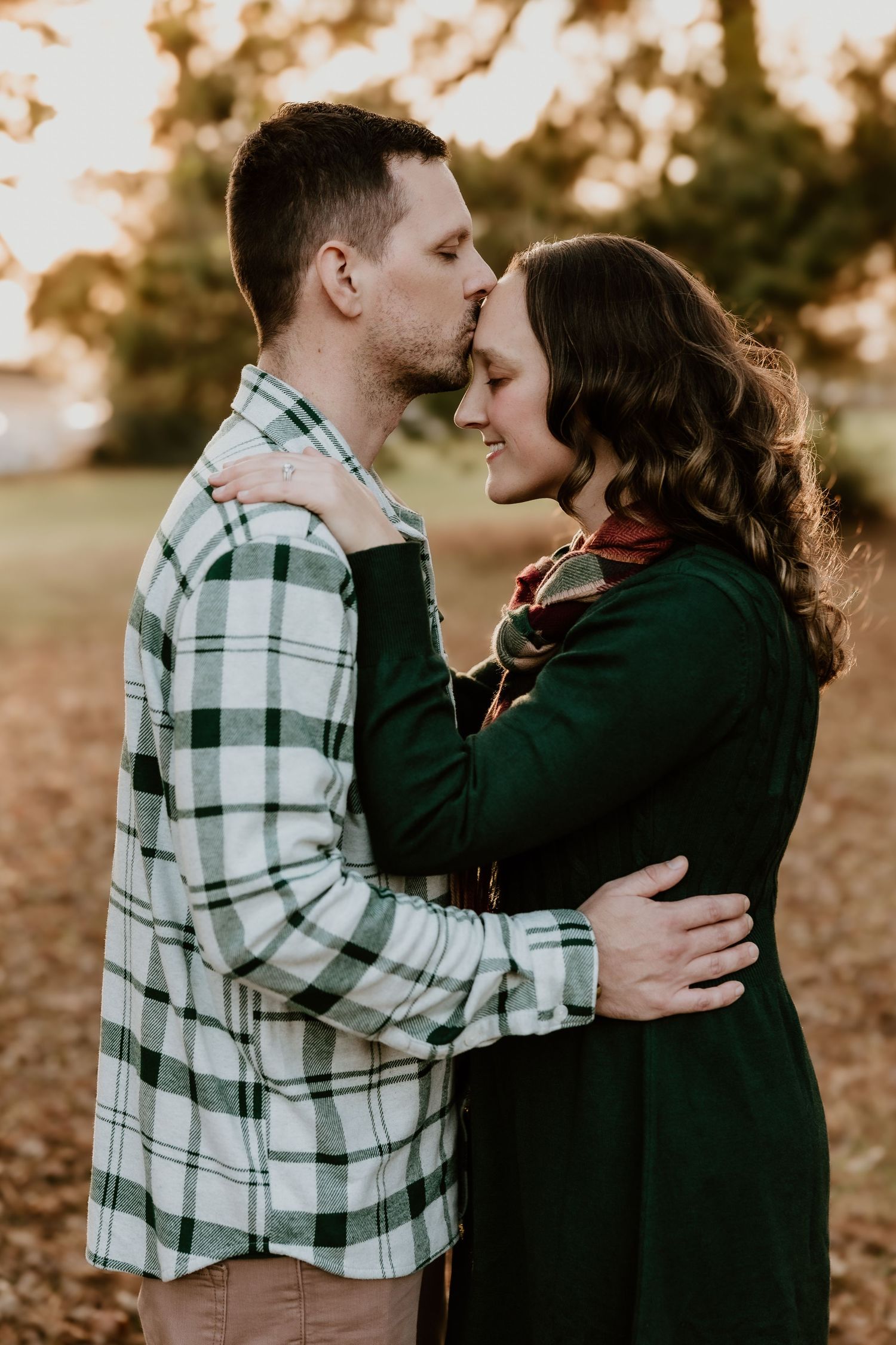 A couple in plaid and black share intimate moments together in a romantic outdoor autumn photoshoot sequence.