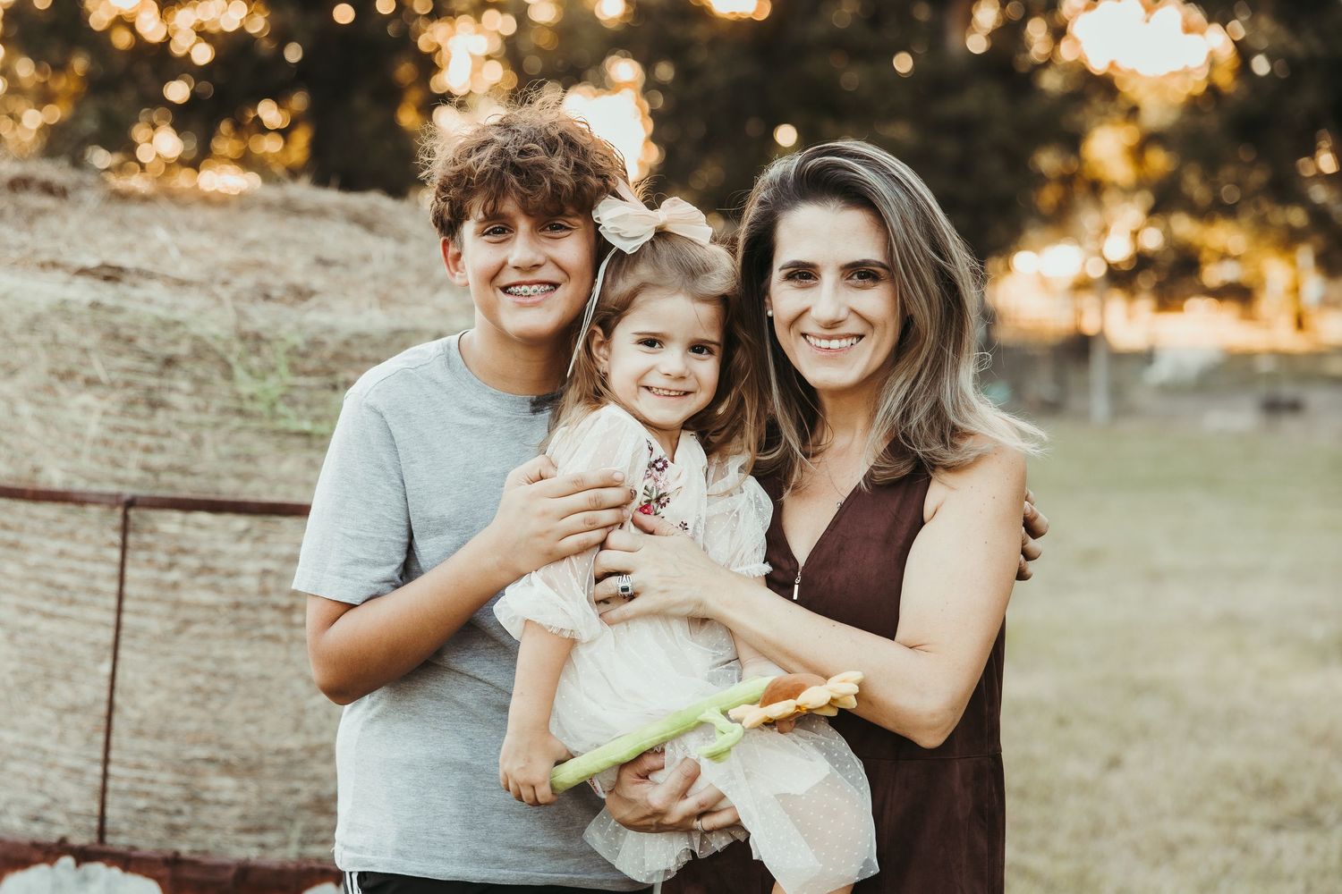 Family gathering outdoors at sunset with casual attire and natural expressions.